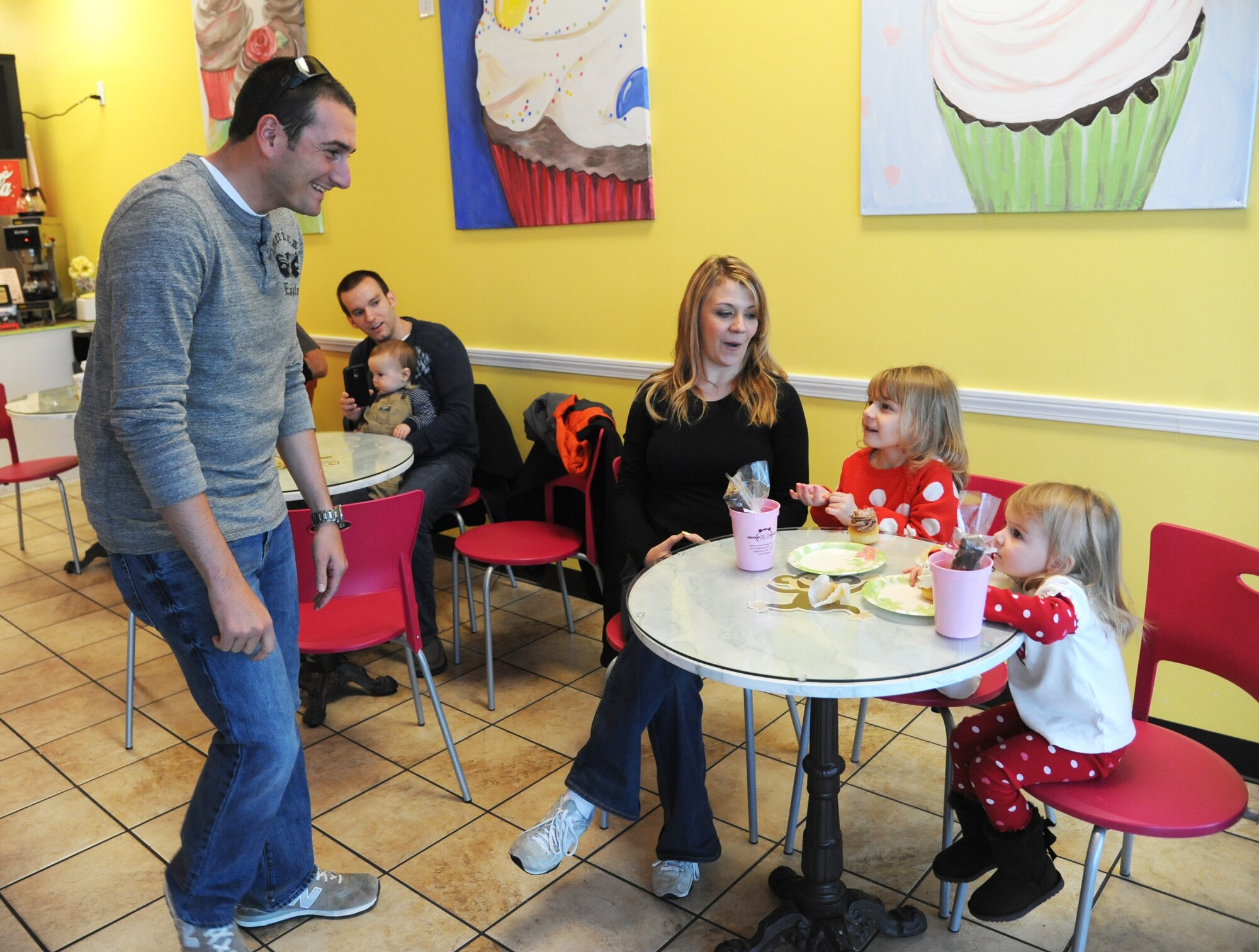 Staff Sgt. Sean Neri, 81st Security Forces Squadron base defense operation center controller and patrolman, surprises his daughters, Izzie and Sophia, as his wife, Ashley, looks on Jan. 4, 2015, at a local bakery, D’Iberville, Miss. Neri returned to Keesler Air Force Base, Miss., Jan. 3 following a six-month deployment to Southwest Asia. (U.S. Air Force photo by Kemberly Groue)