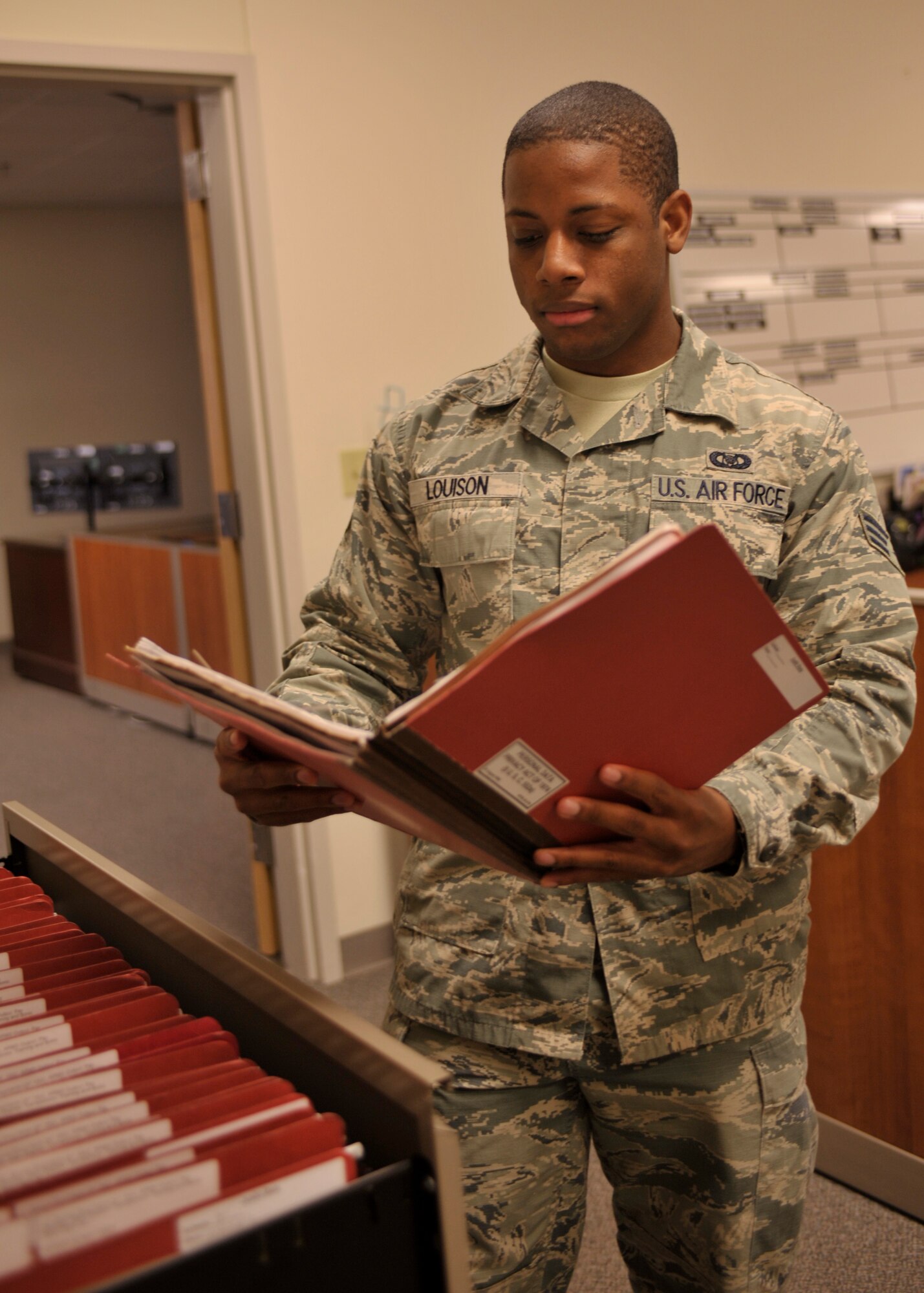 Senior Airman Christopher Louison, 92nd Air Refueling Squadron aviation resource management apprentice, looks through a training file Jan. 21, 2015, at Fairchild Air Force Base, Wash. Louison’s leadership selected him as one of Fairchild’s Finest, a weekly recognition program that highlights top-performing Airmen. (U.S. Air Force photo/Airman 1st Class Taylor Bourgeous)