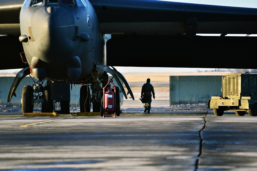 An Airman from the 5th Maintenance Group walks to a B-52H Stratofortress on Minot Air Force Base, N.D., Jan. 12, 2015. Aircraft maintenance Airmen provide maintenance and upkeep to the jets, even during the cold winter months. (U.S. Air Force photo/Senior Airman Brittany Y. Bateman)