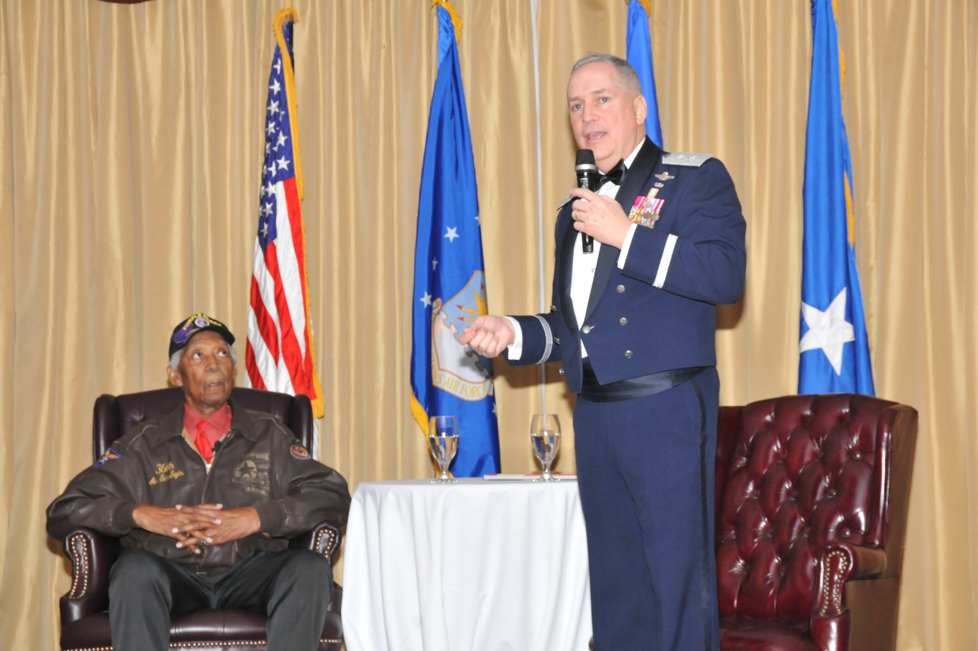 Maj. Gen. Rick Martin, U.S. Air Force Expeditionary Center commander, introduces Retired Tech. Sgt. George Watson Sr., an original Tuskegee Airmen, at the USAF EC Annual Awards Ceremony on Joint Base McGuire-Dix-Lakehurst, N.J., Feb. 4, 2015. Watson, who enlisted in the U.S. Army Air Corps in 1942, was the guest speaker for the ceremony. (US Air Force photo/ Brad Camara)