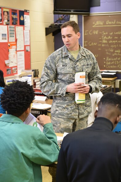 2nd Lt. Ryan Buck, a command and control officer with the 910th Airlift Wing, helps students work through a problem-solving scenario at Choffin Career and Technical Center, Thursday, Feb. 5, 2014. Six Service members from Youngstown Air Reserve Station volunteered their time in conjunction with Junior Achievement of Mahoning Valley to teach career skills and share life experiences with high school students. U.S. Air Force photo/Eric M. White.