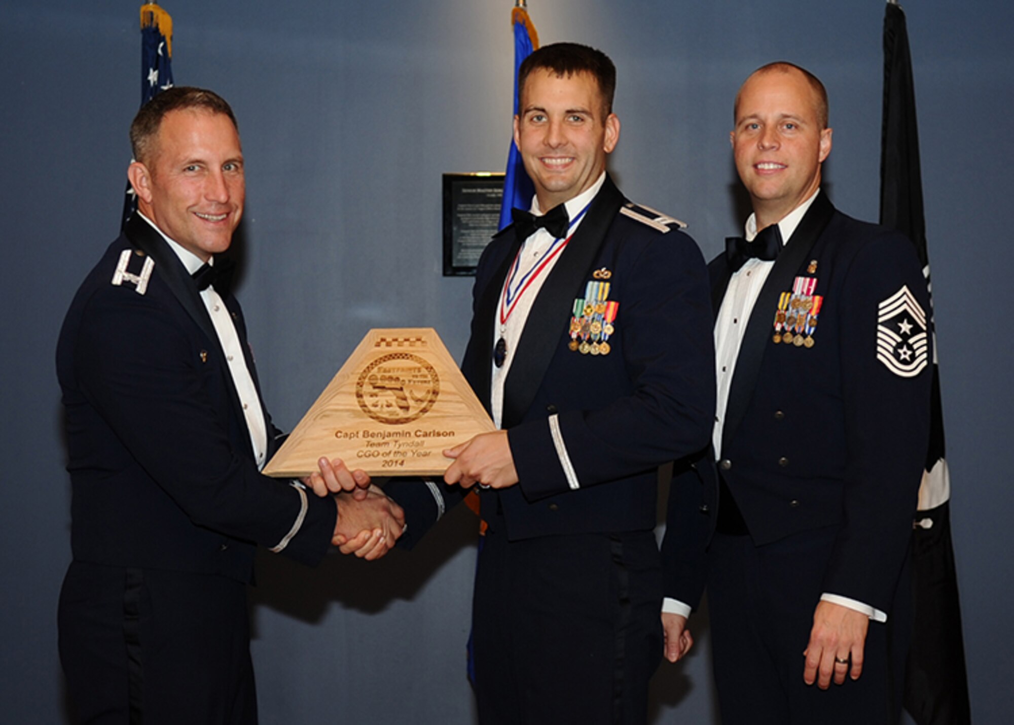 Capt. Benjamin Carlson accepts his second award of the night, the Overall Team Tyndall Company Grade Officer of the Year award, at the annual Team Tyndall Awards banquet Jan. 29, 2015. Earlier in the evening, Carlson was awarded the Tyndall Associate Unit CGO of the Year award. (U.S. Air Force photo/Airman 1st Class Ty-Rico Lea/Released)
