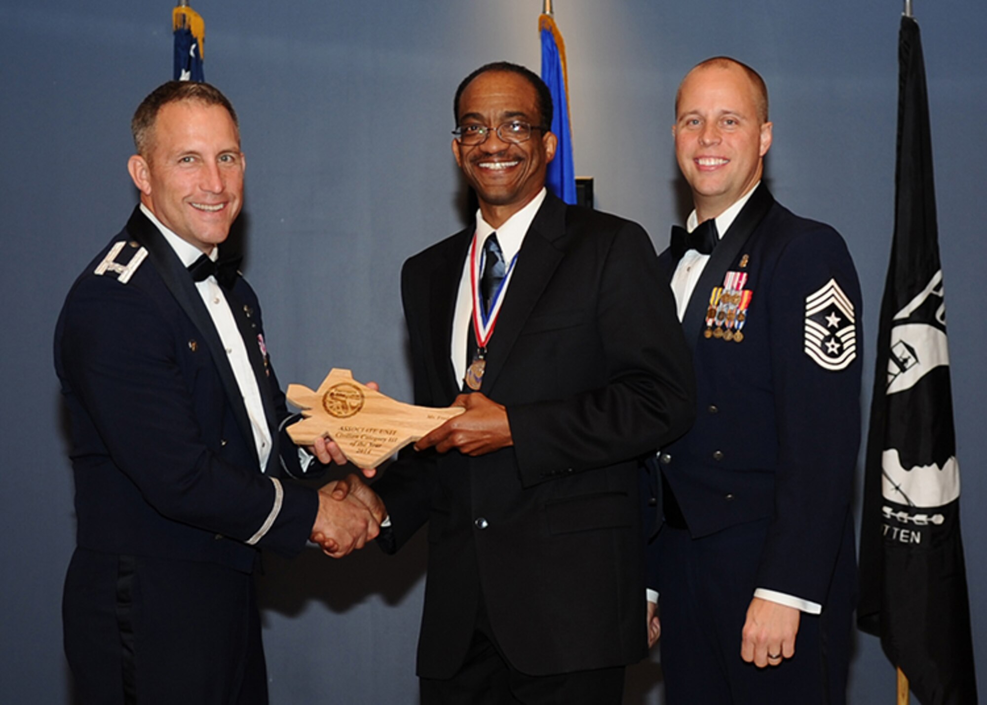 Frederick Cade accepts the Tyndall Associate Unit Category III Civilian of the Year award at the Team Tyndall Awards banquet Jan. 29, 2015. (U.S. Air Force photo/Airman 1st Class Ty-Rico Lea/Released)