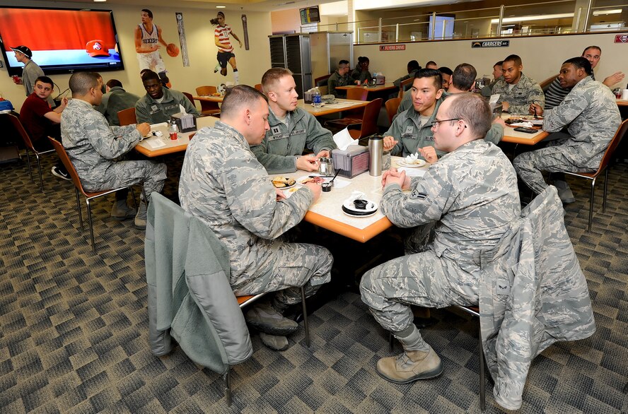 Airmen and civilian employees enjoy food samples provided during the Food Forum at the Patterson Dining Facility on Feb. 4, 2014, at Dover Air Force Base, Del. The forum provided information to the base population on how the Air Force is moving toward more healthy food offerings and other changes of interest to diners. (U.S. Air Force photo/Greg L. Davis)