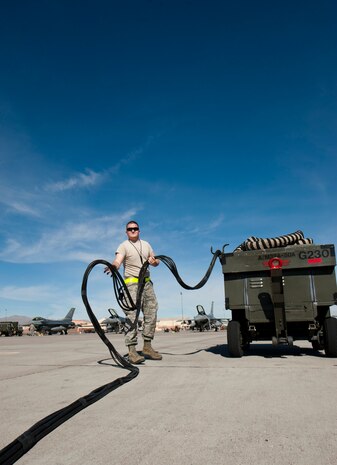 Senior Airman Adam Hagmaier, an F-16 Fighting Falcon electronic warfare systems journeyman assigned to the 158th Fighter Wing, Burlington Air National Guard Base, Vt., prepares to attach power cables to an F-16 during Red Flag 15-1 at Nellis Air Force Base, Nev., Feb. 4, 2015. Red Flag provides a series of realistic air combat scenarios that will help increase combat readiness and effectiveness. (U.S. Air Force photo by Senior Airman Thomas Spangler)