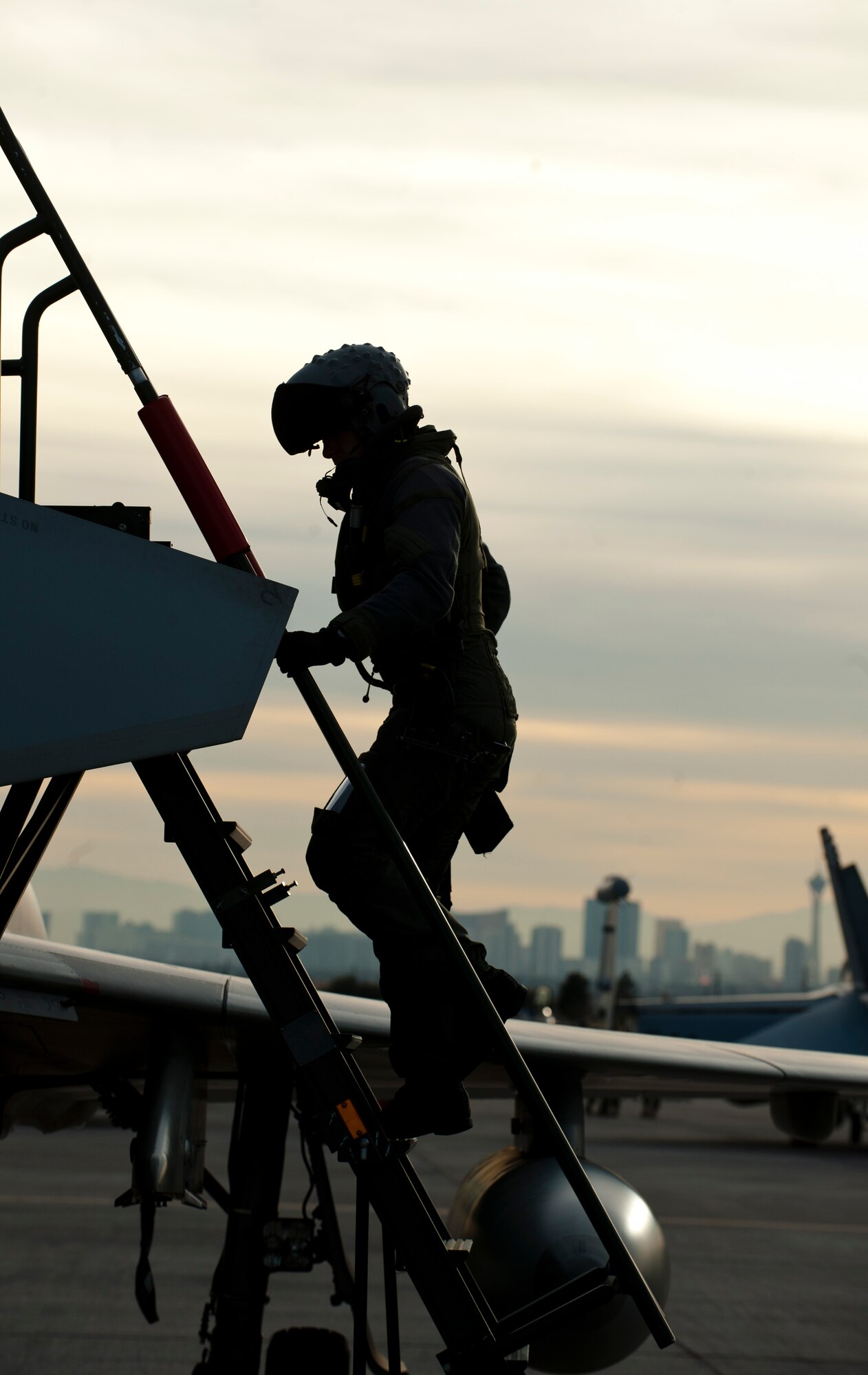Royal Air Force Flight Lieutenant Simon Cook, a Typhoon FGR4 pilot assigned to 1 (Fighter) Squadron, RAF Lossiemouth, Scotland, climbs down from his aircraft after completing a training mission during Red Flag 15-1 at Nellis Air Force Base, Nev., Feb. 2, 2015. Red Flag provides realistic air-to-air combat training scenarios designed to increase cohesiveness between the U.S. and allied nations, as well as combat readiness and effectiveness. (U.S. Air Force photo by Senior Airman Thomas Spangler)