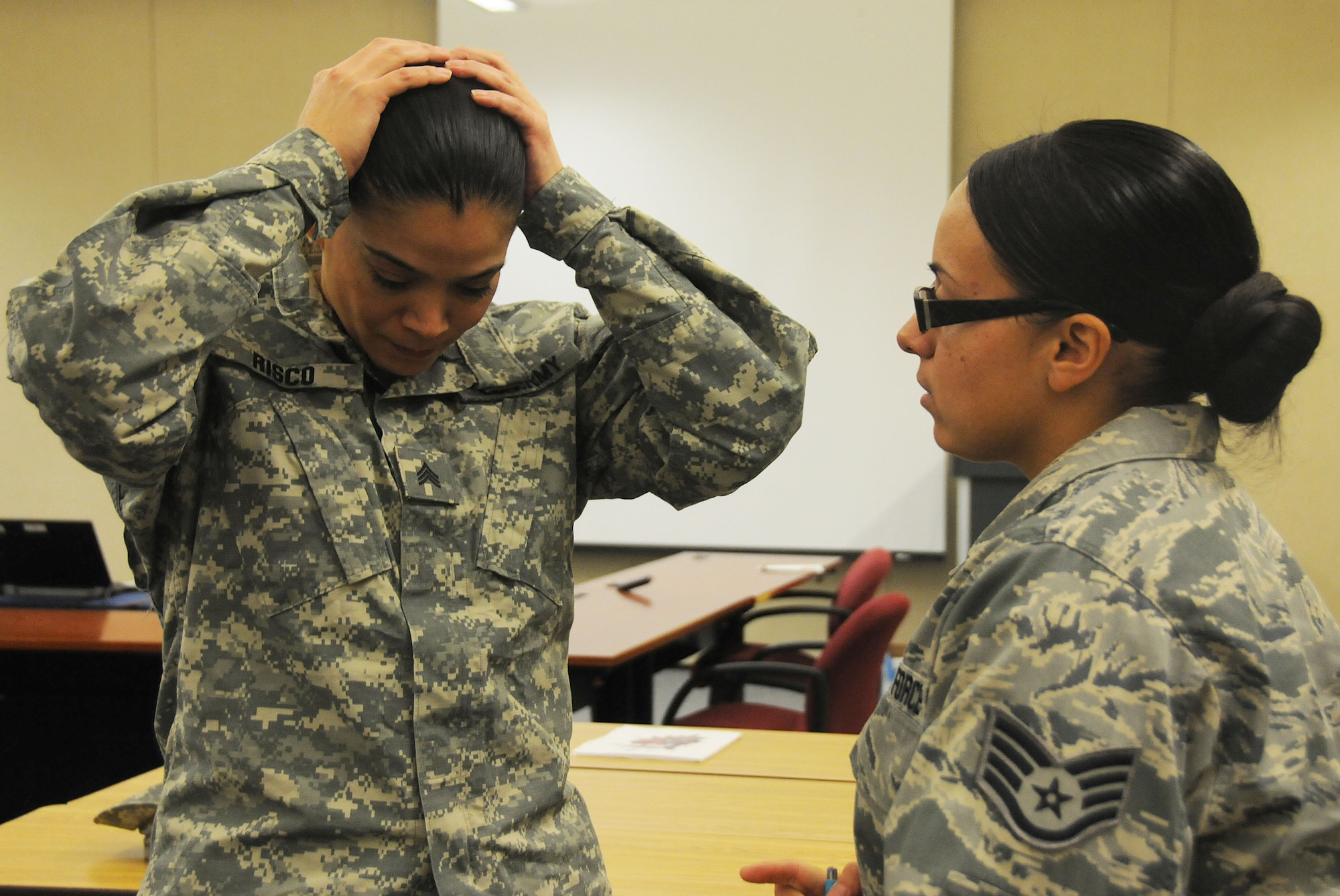 Air Force Staff Sgt. Jennifer Robledo, a future chaplain assistant from the 108th Wing, helps Army Sgt. Xochi Risco, a chaplain assistant from the 42nd Regional Support Group, with her simulated distress during the Traumatic Event Management course Jan. 16, 2015, at Joint Base McGuire-Dix-Lakehurst, N.J. The scenario discussion involved role playing and took place after a fictitious plane crash. Risco played a personwho was heavily effective by the crisis, and walked away from the discussion. Robledo was a facilitator for the scenario and followed right after Risco to console her. The Army's TEM course is a week long and focuses on unit cohesion and effectiveness to help manage crisis situations. The course focuses on group activities and role playing to reinforce the lessons. At the end of the week, the students are able to take what they learned and bring it back to their units. (U.S. Air National Guard Photo by Airman 1st Class Julia Pyun/Released)
