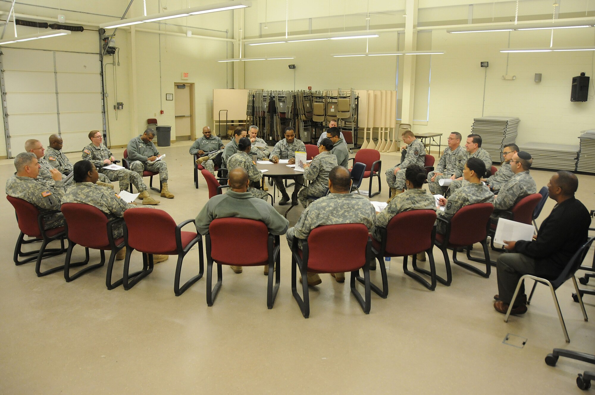 Army and Air Force chaplains and chaplain assistants from all over N.J., sit at a simulated discussion during the Traumatic Event Management course Jan. 16, 2015, at Joint Base McGuire-Dix-Lakehurst, N.J. The scenario discussion took place after a fictitious plane crash. The Army's TEM course was a week long and focused on unit cohesion and effectiveness to help manage crisis situations. The course used on group activities and role playing to reinforce the lessons. At the end of the week, the students are able to take what they learned and bring it back to their units. (U.S. Air National Guard Photo by Airman 1st Class Julia Pyun/Released)