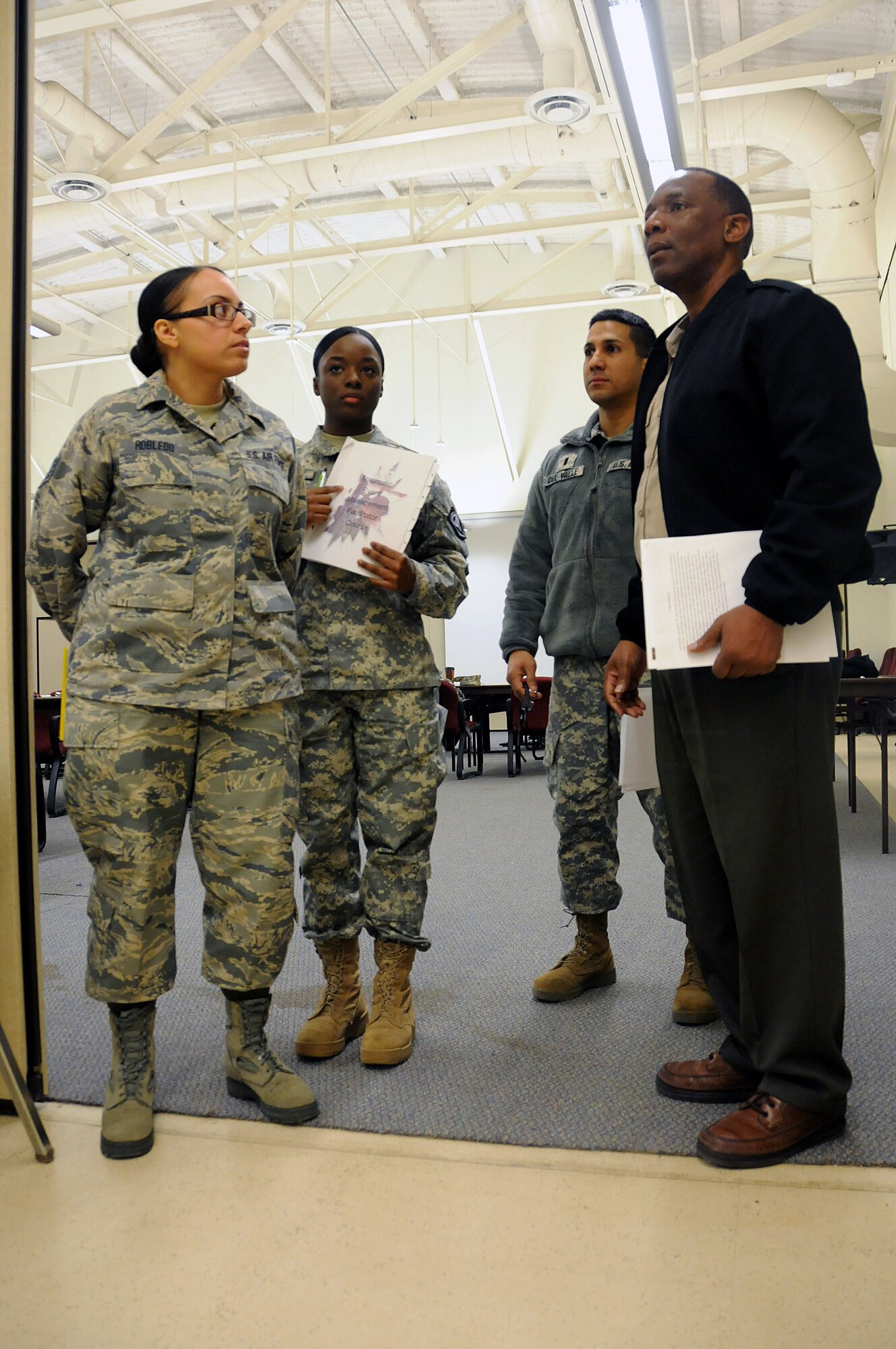Air Force Staff Sgt. Jennifer Robledo, a future chaplain assistant from the 108th Wing, left, Army Pfc. Mahalia Reevey, a chaplain's assistant from the 117th Combat Sustainment Support Battalion, center left, Army 1st Lt. Joseph Del Valle, a chaplain from the 102nd Cavalry Regimnet, and an instructor from (AMEDDC), are waiting to start the scenario discussion during the Traumatic Event Management Course Jan. 16, 2015, at Joint Base McGuire-Dix-Lakehurst, N.J. The Army's TEM course was a week long and focused on unit cohesion and effectiveness to help manage crisis situations. The course used group activities and role playing to reinforce the lessons. At the end of the week, the students are able to take what they learned and bring it back to their units. (U.S. Air National Guard Photo by Airman 1st Class Julia Pyun/Released)