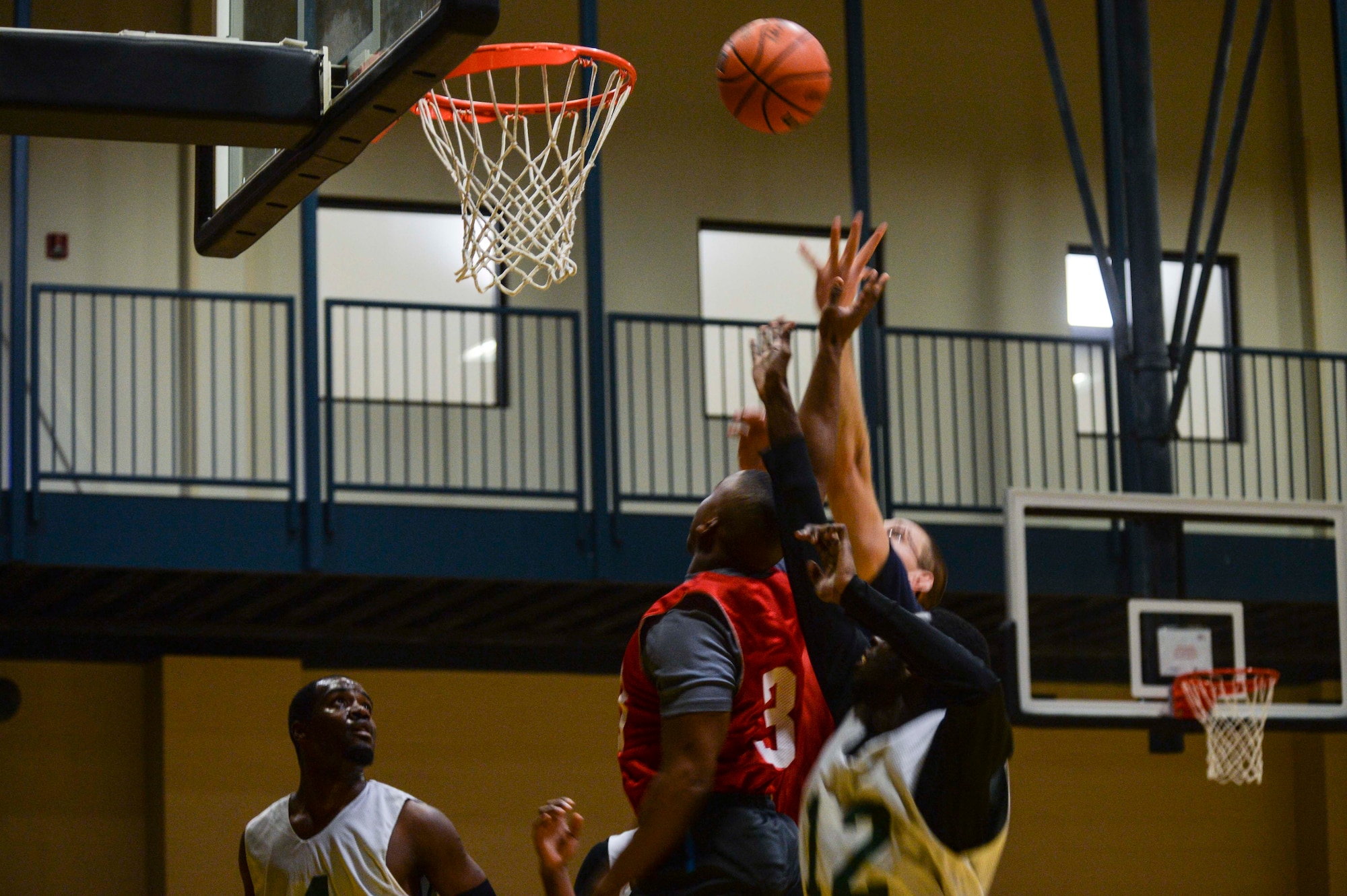 Bryan Coleman, a guard for the 314th Aircraft Maintenance Squadron, watches as his teammates fight for a rebound during intramural basketball, Feb. 2, 2014, at Little Rock Air Force Base, Ark. (U.S. Air Force photo/Senior Airman Cliffton Dolezal)