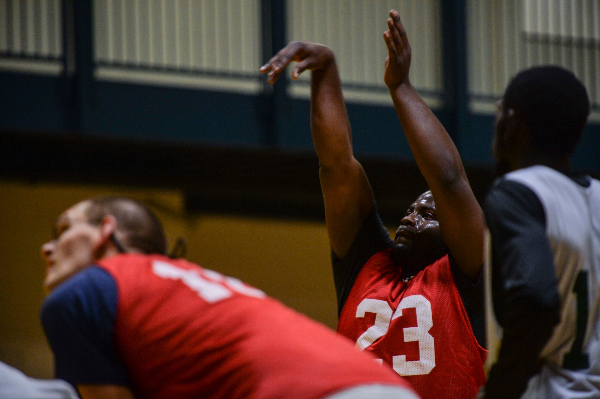 Bryan Coleman, a guard for the 314th Aircraft Maintenance Squadron, watches as his teammates fight for a rebound during intramural basketball, Feb. 2, 2014, at Little Rock Air Force Base, Ark. (U.S. Air Force photo/Senior Airman Cliffton Dolezal)