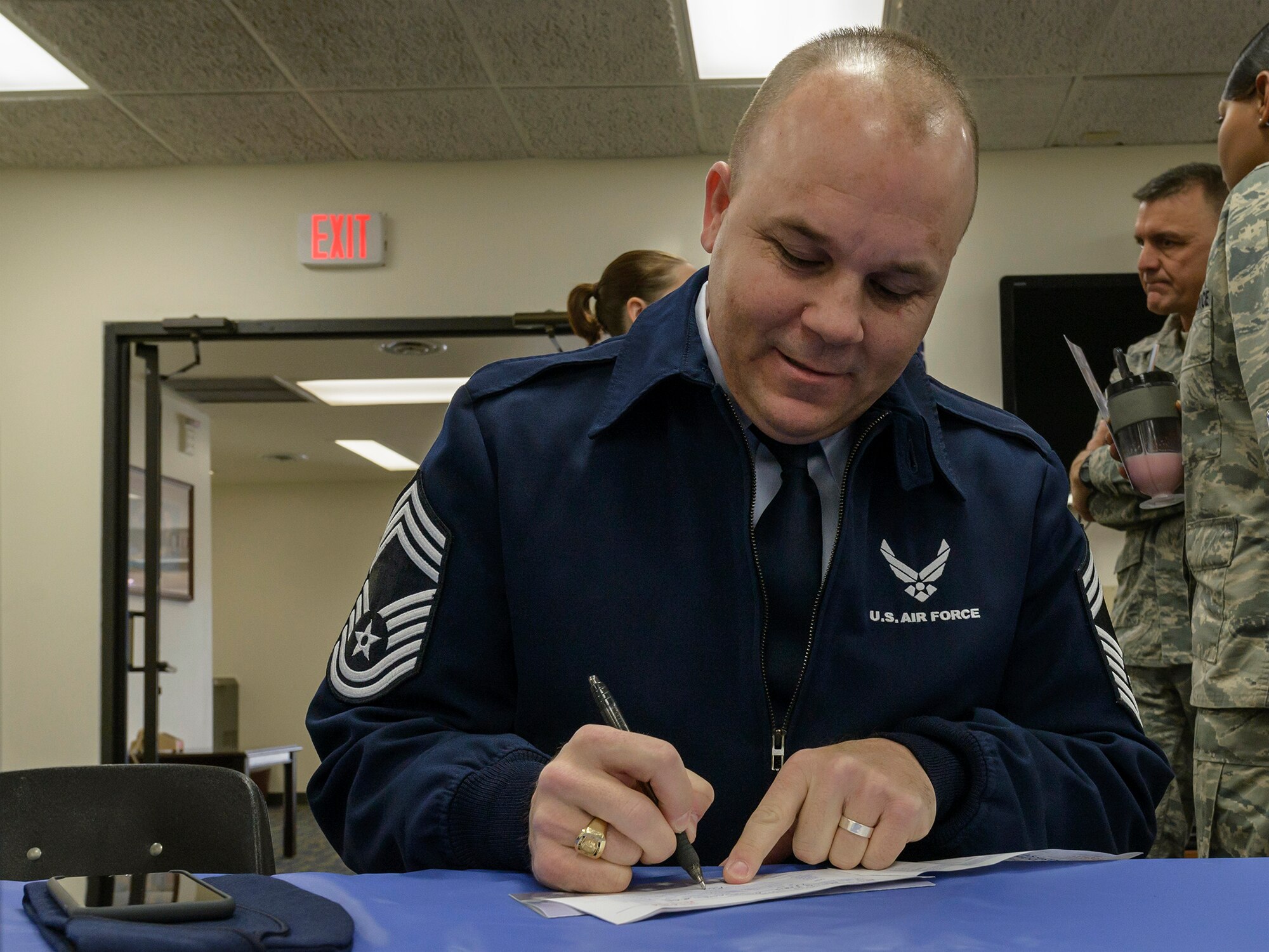 VANCE AIR FORCE BASE, Okla. -- Chief Master Sgt. Kraig Chapman, the 71st Operations Support Squadron chief controller, fills out his Air Force Assistance Fund contribution form at the Community Chapel Activity Center Feb. 2. Chapman joined Airmen from across Team Vance for an AFAF kickoff breakfast organized by 33rd Flying Training Squadron. (U.S. Air Force photo / David Poe)
