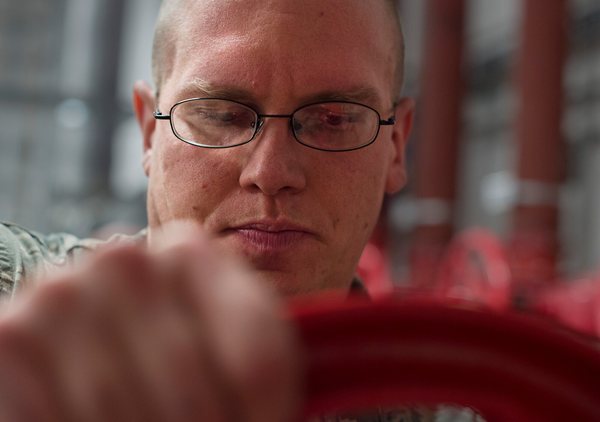 Staff Sgt. Benjamin Schultz, 786th Civil Engineer Squadron fire suppression team lead, operates one of the many control valves at Ramstein Air Base, Germany, Jan. 29, 2015. Each control valve is required to be tested on its complete range of motion every two years. (U.S. Air Force photo/Senior Airman Damon Kasberg)