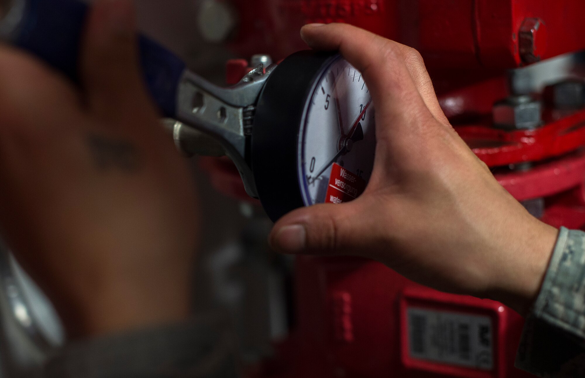 Staff Sgt. Jonathan Lucero, 786th Civil Engineer Squadron assistant lead, removes a system gauge to test it for accuracy in the Kaiserslautern Military Community Center at Ramstein Air base, Germany, Jan. 29, 2015. If these tests are not performed, there wouldn’t be assurance that the system would function as designed. Without a proper functioning fire suppression system in the KMCC lives and property could be lost if a fire broke out. (U.S. Air Force photo/Senior Airman Damon Kasberg)