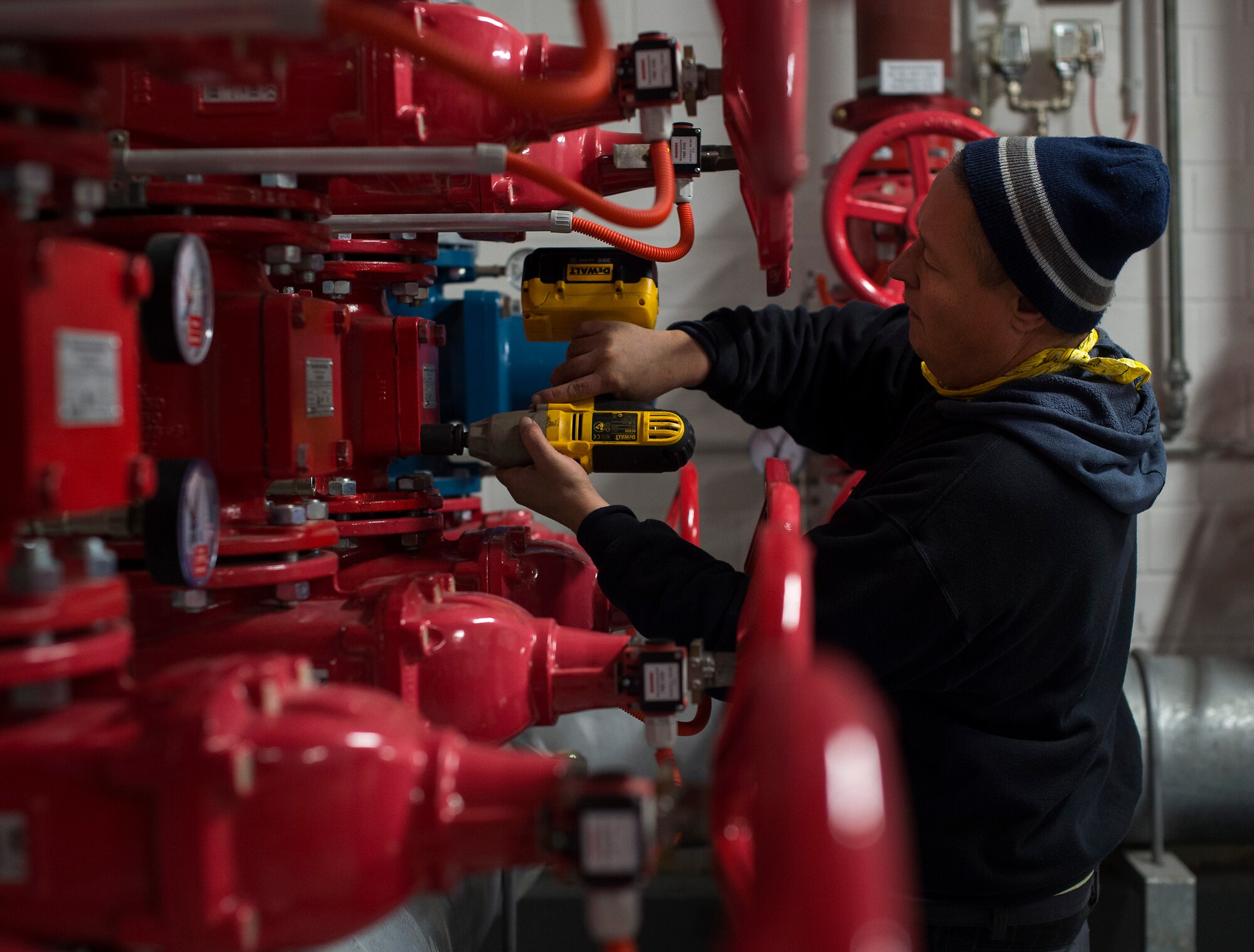 Frank Lass, 786th Civil Engineer fire suppression system specialist, reinstalls an alarm check valve cover plate prior to refilling the system with water at Ramstein Air Base, Germany, Jan. 29, 2015. The 786th CES is responsible for the inspection, testing and maintenance of 127 fire suppression systems facilities throughout the Kaiserslautern Military Community. (U.S. Air Force photo/Senior Airman Damon Kasberg)
