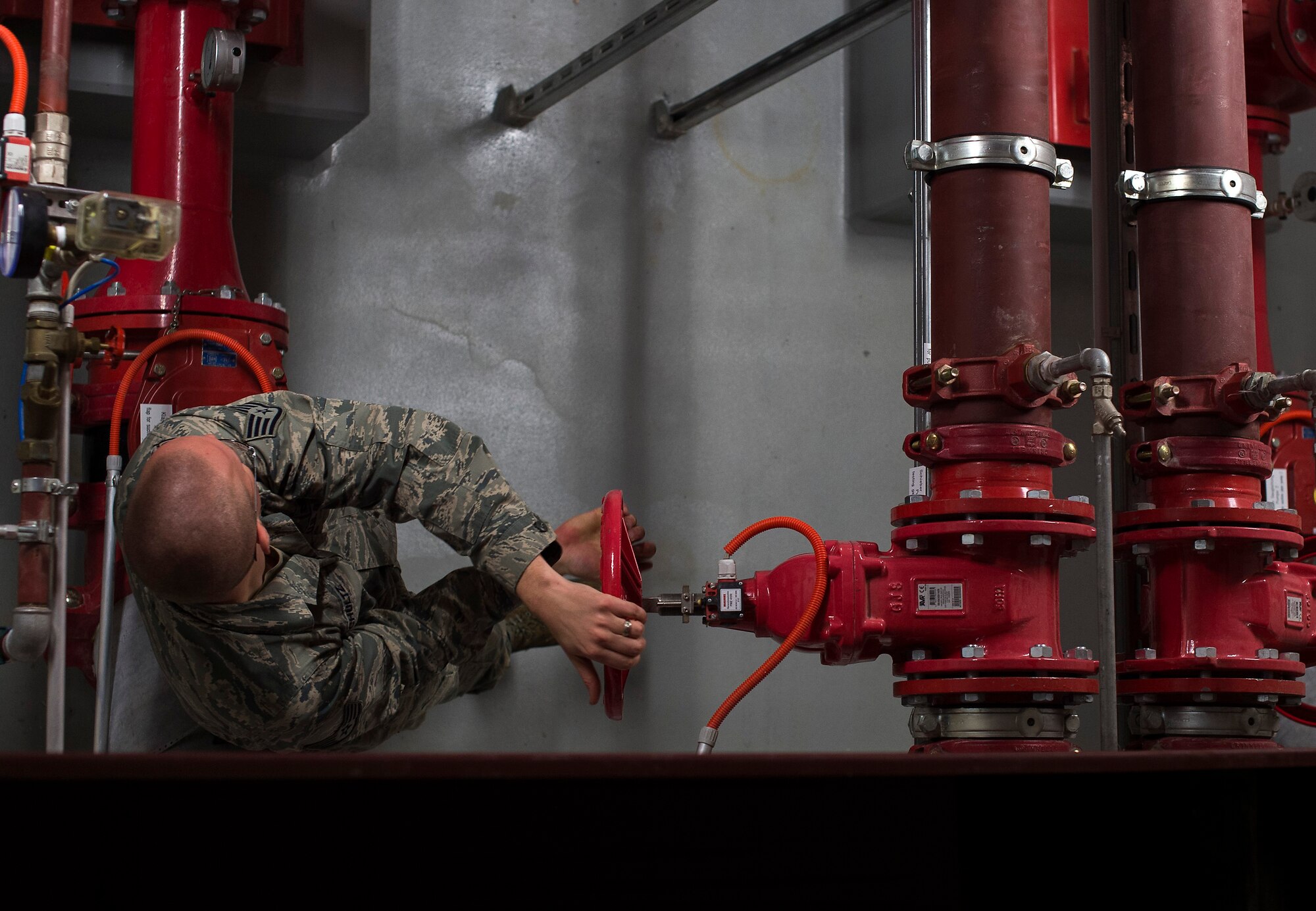 Staff Sgt. Benjamin Schultz, 786th Civil Engineer Squadron fire suppression team lead, turns a valve to circulate water from the fire suppression system during a monthly pump check at Ramstein Air Base, Germany, Jan. 29, 2015. The 786th CES is responsible for the inspection, testing and maintenance of 127 fire suppression systems facilities throughout the Kaiserslautern Military Community. (U.S. Air Force photo/Senior Airman Damon Kasberg)