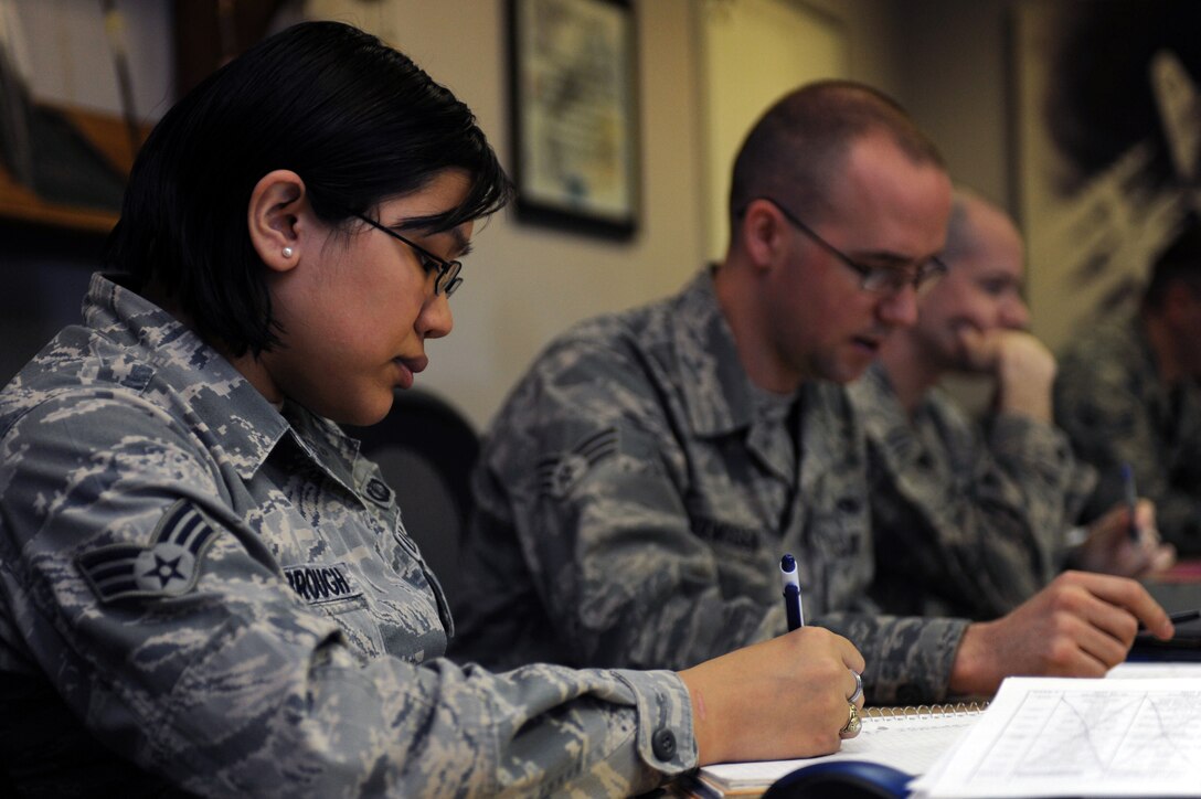 Senior Airman Christine Yarbrough, 28th Comptroller Squadron financial analyst, and other Airman Leadership School students from Class 15-3 review homework at Ellsworth Air Force Base, S.D., Jan. 29, 2015. During ALS, Airmen participate in discussions ranging from interpersonal communications and diversity within the Air Force to performing uniform inspections and marching in formation. (U.S. Air Force photo by Senior Airman Hailey R. Staker/Released)