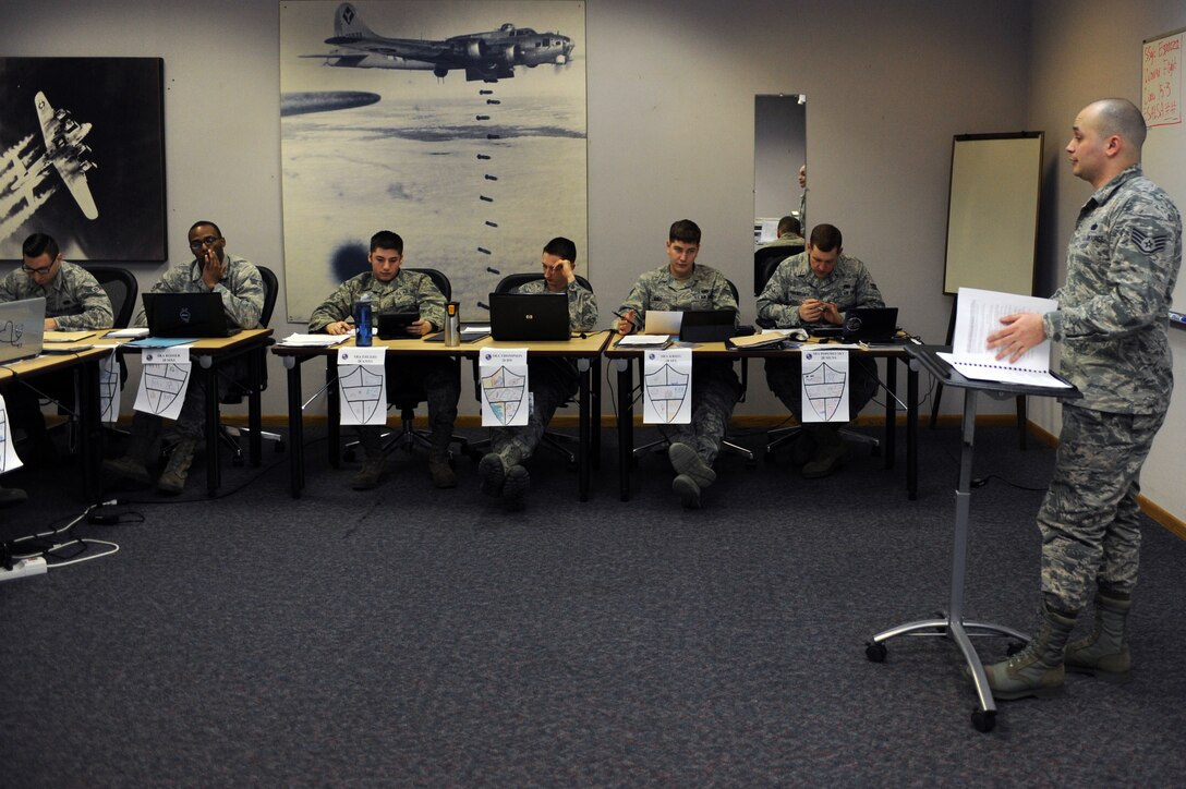 Staff Sgt. Anthony Espinoza, 28th Force Support Squadron Airman Leadership School instructor, reviews homework with Airman Leadership School Class 15-3 at Ellsworth Air Force Base, S.D., Jan. 29, 2015. Airman Leadership School is a five-week program designed to develop Senior Airmen into front-line supervisors while emphasizing management styles and effective leadership. (U.S. Air Force photo by Senior Airman Hailey R. Staker/Released)