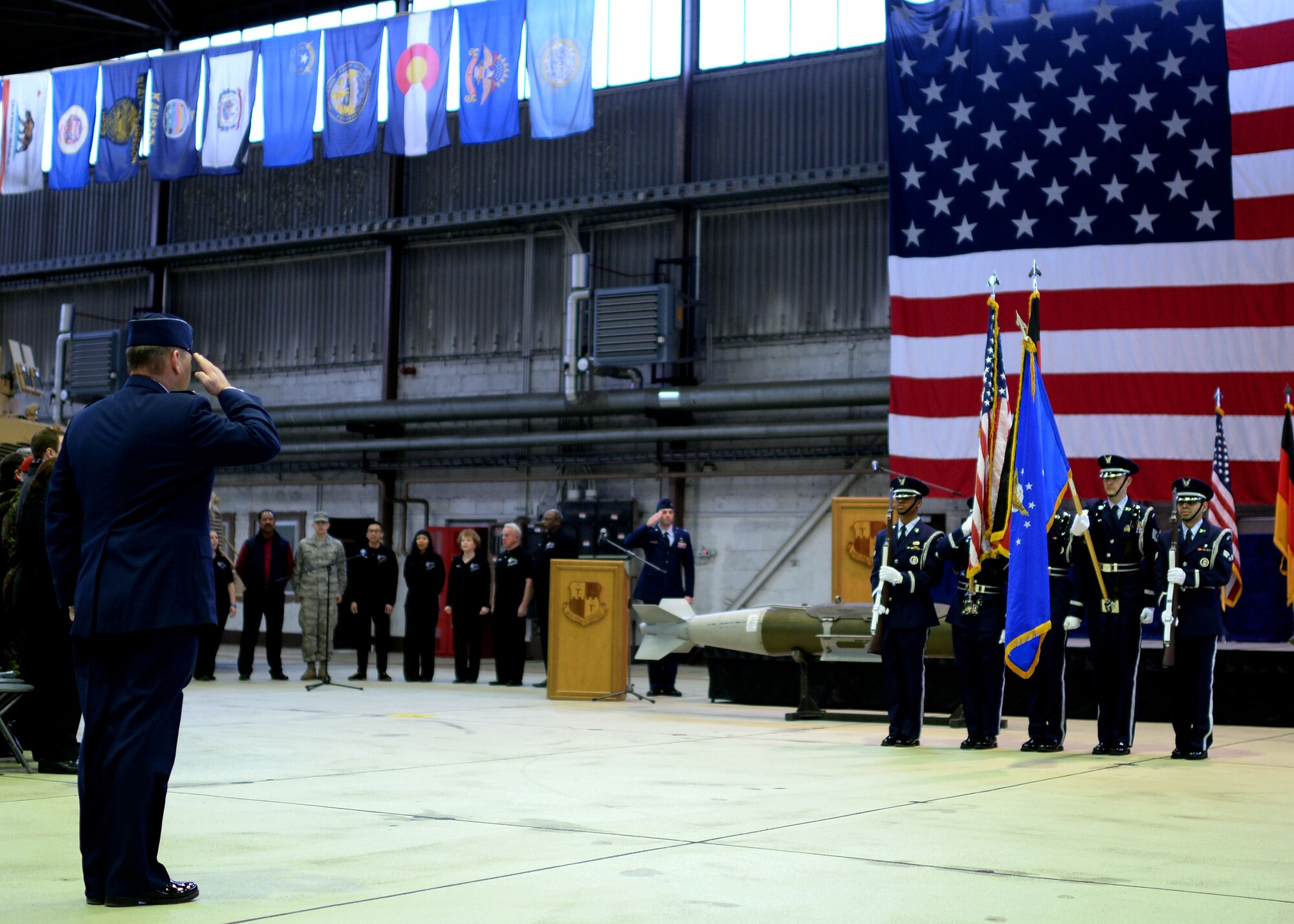 U.S. Air Force Col. Lars Hubert, 52nd Fighter Wing vice commander, salutes the 52nd Force Support Squadron Honor Guard during the singing of the national anthem at an assumption of command ceremony in Hangar 1 at Spangdahlem Air Base, Germany, Feb. 5, 2015. Hubert acted as the commander of the 52nd FW until U.S. Air Force Col. Joseph McFall could assume responsibility of the wing. (U.S. Air Force photo by Staff Sgt. Daryl Knee/Released)