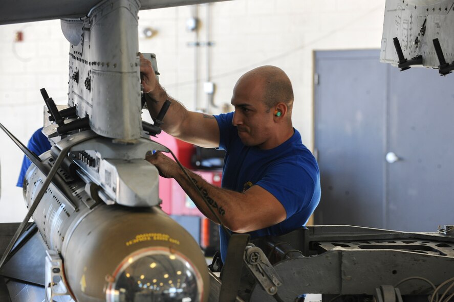 U.S. Air Force Staff Sgt. Cedric Abolos, 74th Aircraft Maintenance Unit load crew chief, locks in an AGM-65 Maverick to the bomb rack Jan. 30, 2015, at Moody Air Force Base, Ga. Airmen with the best loading records throughout the previous quarter were selected to participate in the quarterly weapons load competition.(U.S. Air Force photo by Senior Airman Sandra Marrero/Released)