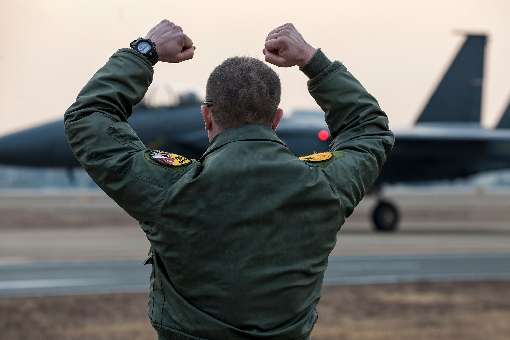 Maj. Dean Laansma, 80th Fighter Squadron assistant director of operations and Exercise Buddy Wing detachment commander, gives the ‘crush em’ sign to an F-15K Slam Eagle during Exercise Buddy Wing 15-2 at Daegu Air Base, Republic of Korea, Feb. 5, 2015. The 8th Fighter Wing deployed four F-16s to support the four-day exercise. (U.S. Air Force photo by Senior Airman Katrina Heikkinen/Released)