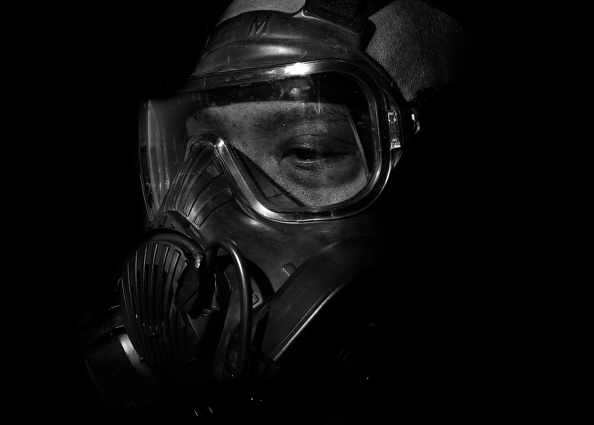 U.S. Air Force Capt. Derrick Jones, 31st Mission Support Group chief of education and training, dons a M50 Joint Service General Purpose Field Mask during a gasmask fit test, Jan. 3, 2015, at Aviano Air Base, Italy. The M50 gas mask is designed to protect against chemical, biological and radiological threats. Members are required to have an up-to-date gasmask fit test certificate for deployments. Once a fit test certificate is conducted, it does not expire unless an Airman loses or gains 10 percent of their body weight or goes through reconstructive facial surgery. (U.S. Air Force photo by Airman 1st Class Ryan Conroy/Released)