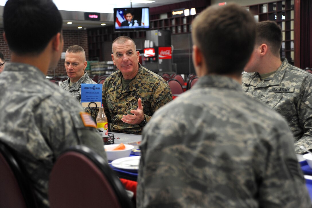 U.S. Marine Corps Sgt. Maj. Bryan Battaglia, center right, senior enlisted advisor to the chairman of the Joint Chiefs of Staff, and U.S. Army Command Sgt. Maj. John Troxell, left, senior enlisted advisor to U.S. Forces Korea visit with junior enlisted service members during breakfast on Yongsan Garrison in Seoul, South Korea, Feb. 4, 2015. 