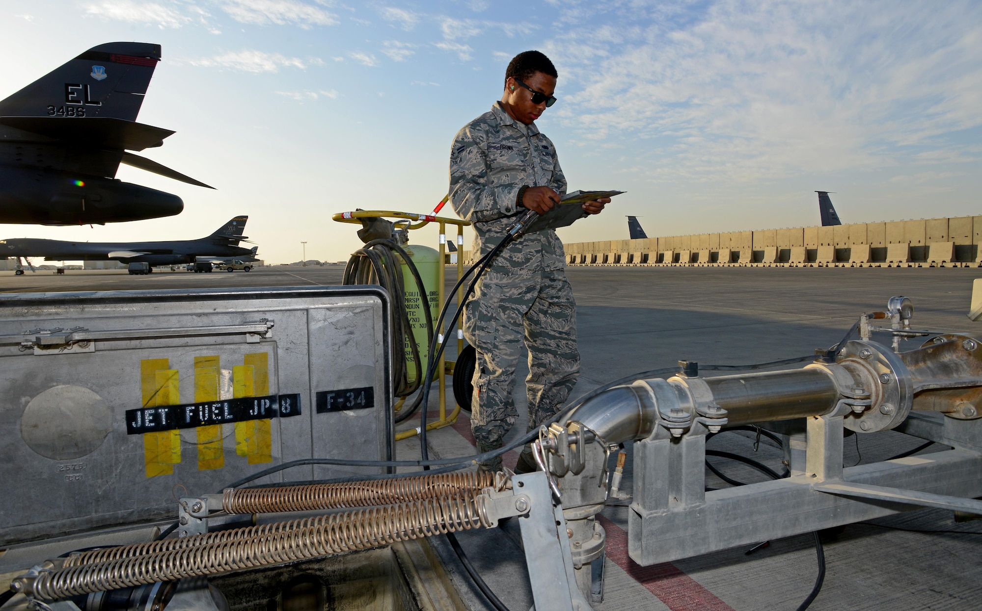 Airman 1st Class Reese Brown, 379th Expeditionary Logistics Readiness Squadron fuels specialist, uses a pantograph to fuel an R-11 refueler at Al Udeid Air Base, Qatar, Feb. 5, 2015.  Since 2001, the 379th ELRS fuels flight has delivered more than three billion gallons of aviation and ground fuel in support of operations Enduring Freedom and Iraqi Freedom. (U.S. Air Force photo by Master Sgt. Kerry Jackson) 