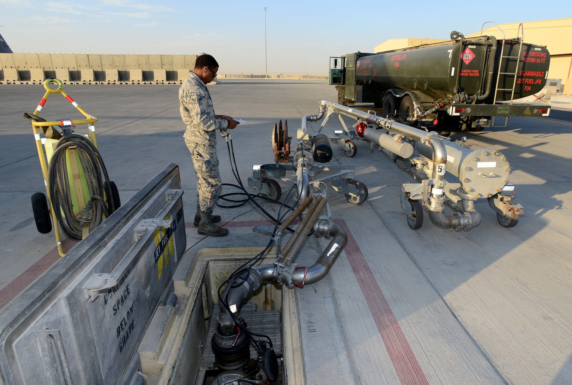Airman 1st Class Reese Brown, 379th Expeditionary Logistics Readiness Squadron, fuels specialist uses a pantograph to fuel an R-11 refueler at Al Udeid Air Base, Qatar, Feb. 5, 2015.  Since 2001, the 379th ELRS fuels flight has delivered more than three billion gallons of aviation and ground fuel in support of operations Enduring Freedom and Iraqi Freedom. (U.S. Air Force photo by Master Sgt. Kerry Jackson)