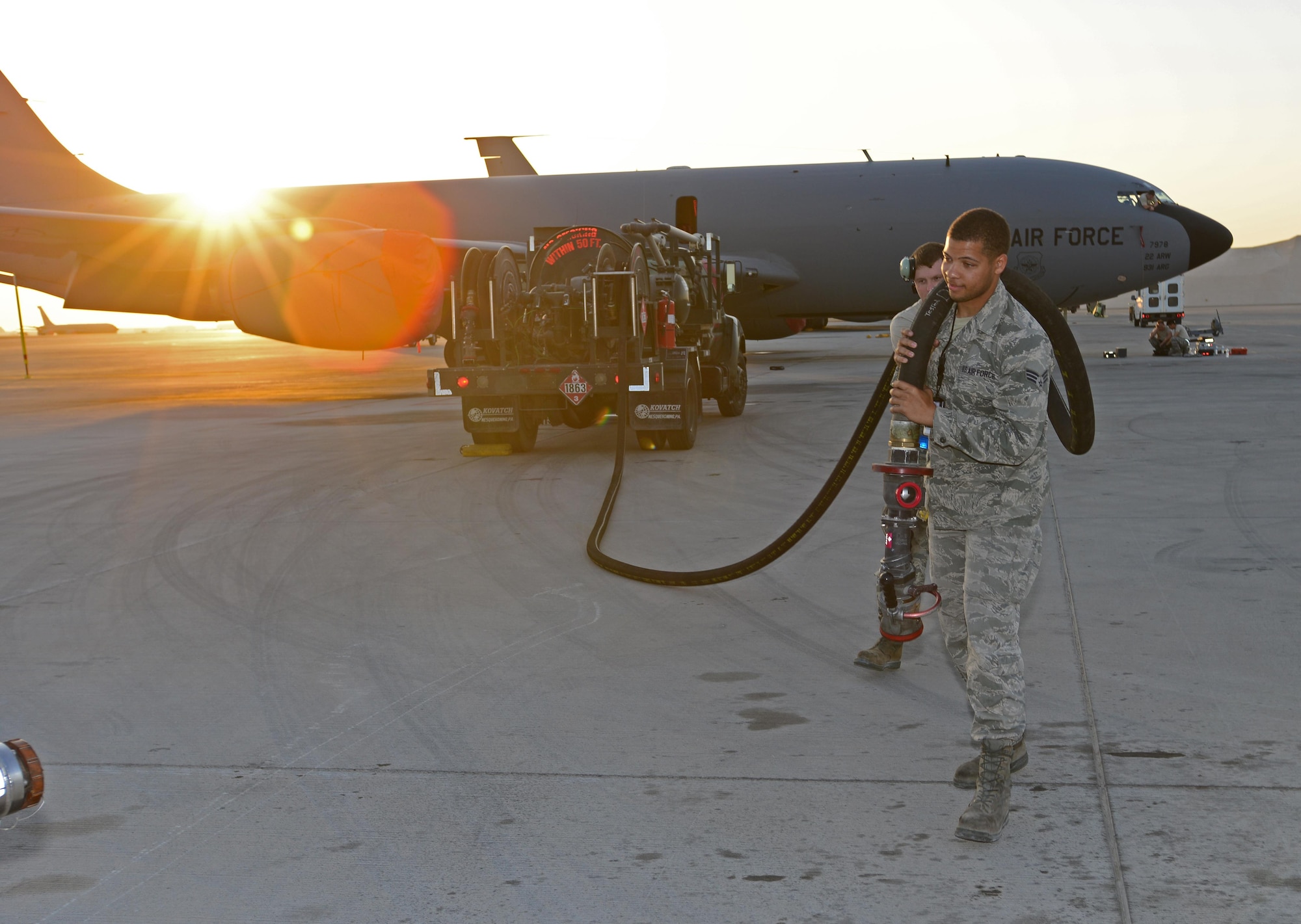 Airman 1st Class Jovonte Atkins, 379th Expeditionary Logistics Readiness Squadron fuels specialist extend a fuels hose from a R-12 refueler to refuel an aircraft at Al Udeid Air Base, Qatar, Feb. 5, 2015. Since 2001, the 379th ELRS fuels flight has delivered more than three billion gallons of aviation and ground fuel in support of operations Enduring Freedom and Iraqi Freedom. (U.S. Air Force photo by Master Sgt. Kerry Jackson)   
