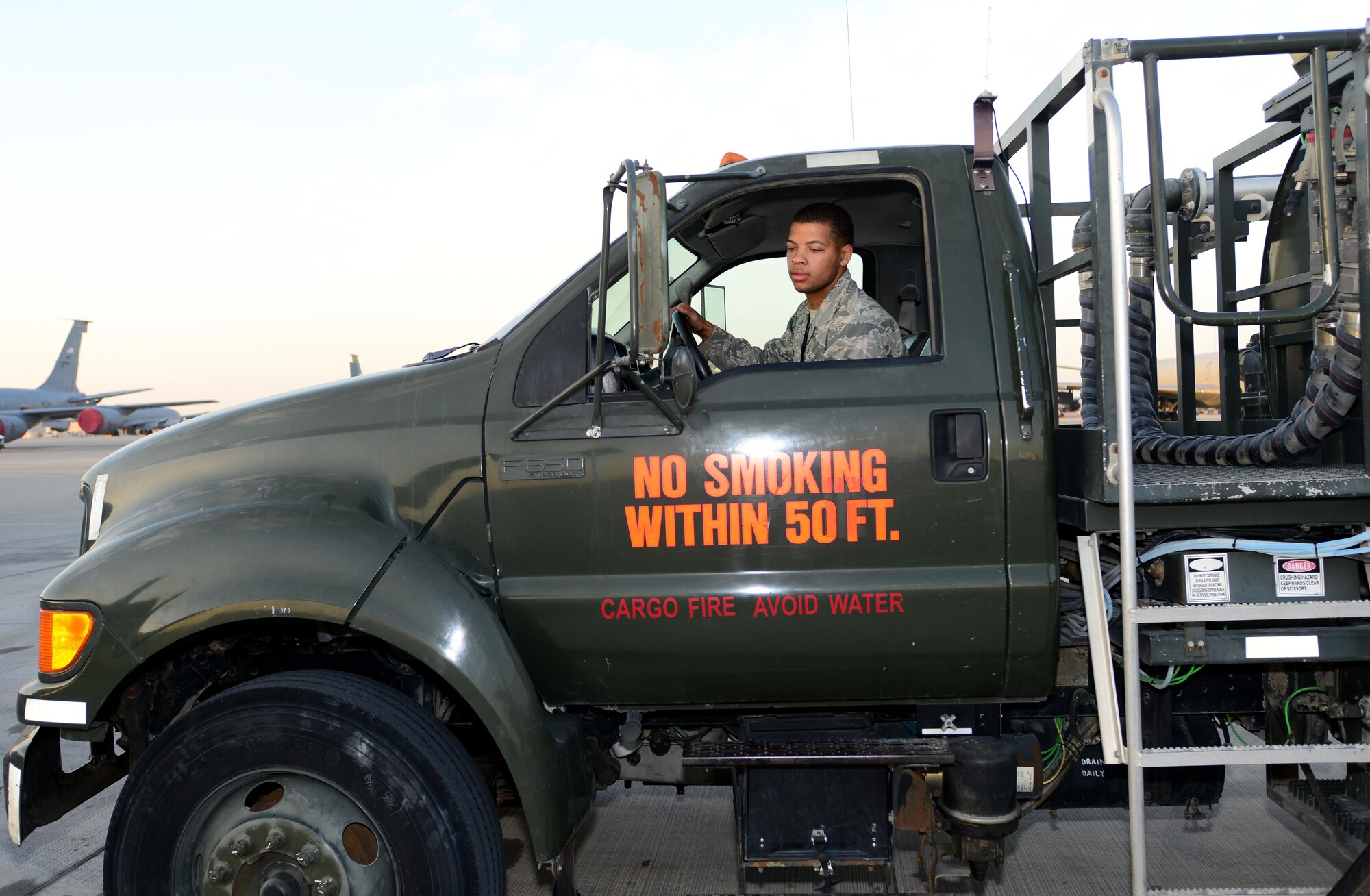 Airman 1st Class Jovonte Atkins, 379th Expeditionary Logistics Readiness Squadron fuels specialist, drives an R-12 refueler truck to refuel an aircraft at Al Udeid Air Base, Qatar, Feb. 5, 2015. Since 2001, the 379th ELRS fuels flight has delivered more than three billion gallons of aviation and ground fuel in support of operations Enduring Freedom and Iraqi Freedom. (U.S. Air Force photo by Master Sgt. Kerry Jackson)