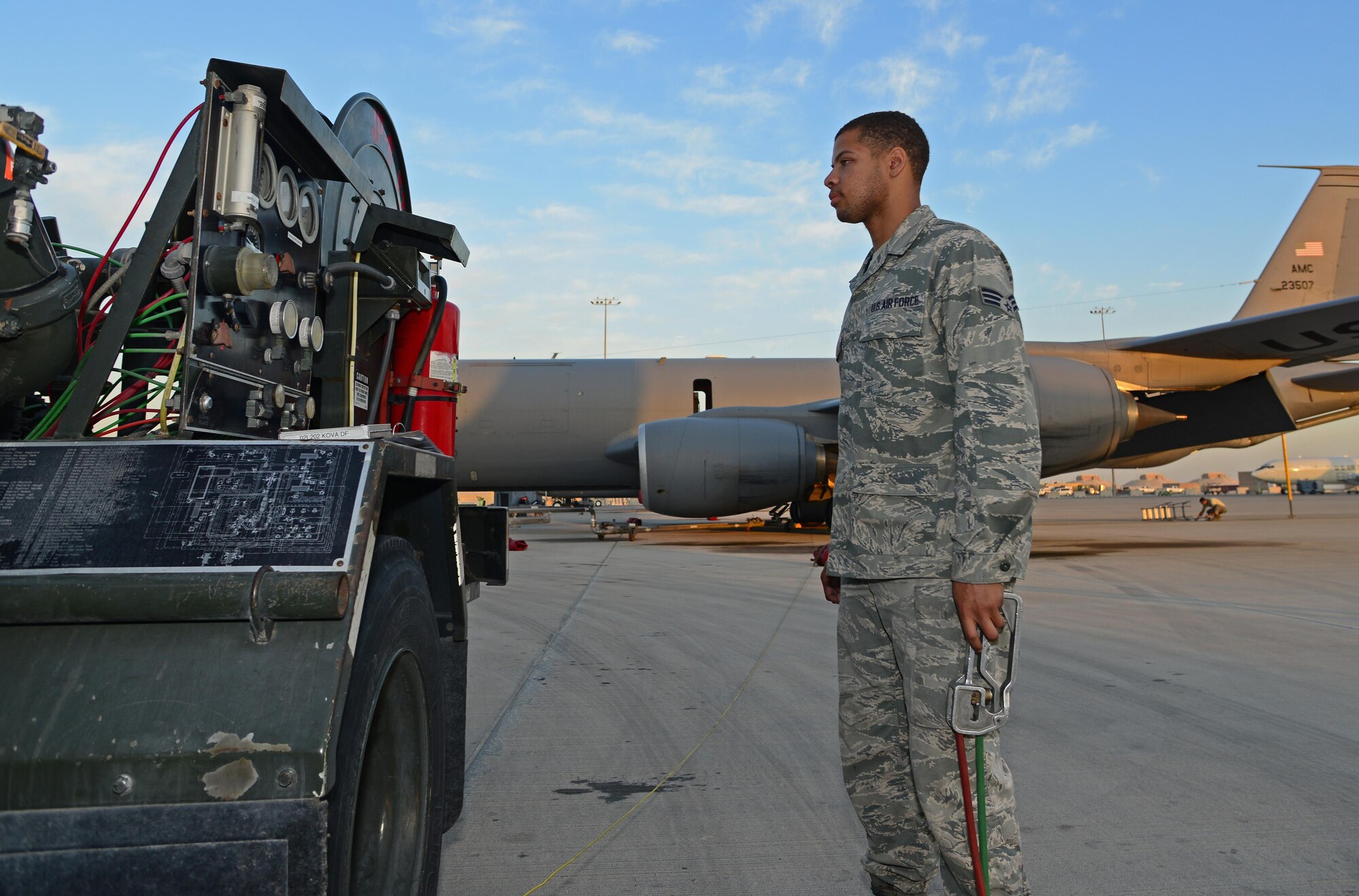 Airman 1st Class Jovonte Atkins, 379th Expeditionary Logistics Readiness Squadron fuels specialist, monitors an R-12 fuel control panel while refueling an aircraft at Al Udeid Air Base, Qatar, Feb. 5, 2015. Since 2001, the 379th ELRS fuels flight has delivered more than three billion gallons of aviation and ground fuel in support of operations Enduring Freedom and Iraqi Freedom. (U.S. Air Force photo by Master Sgt. Kerry Jackson)