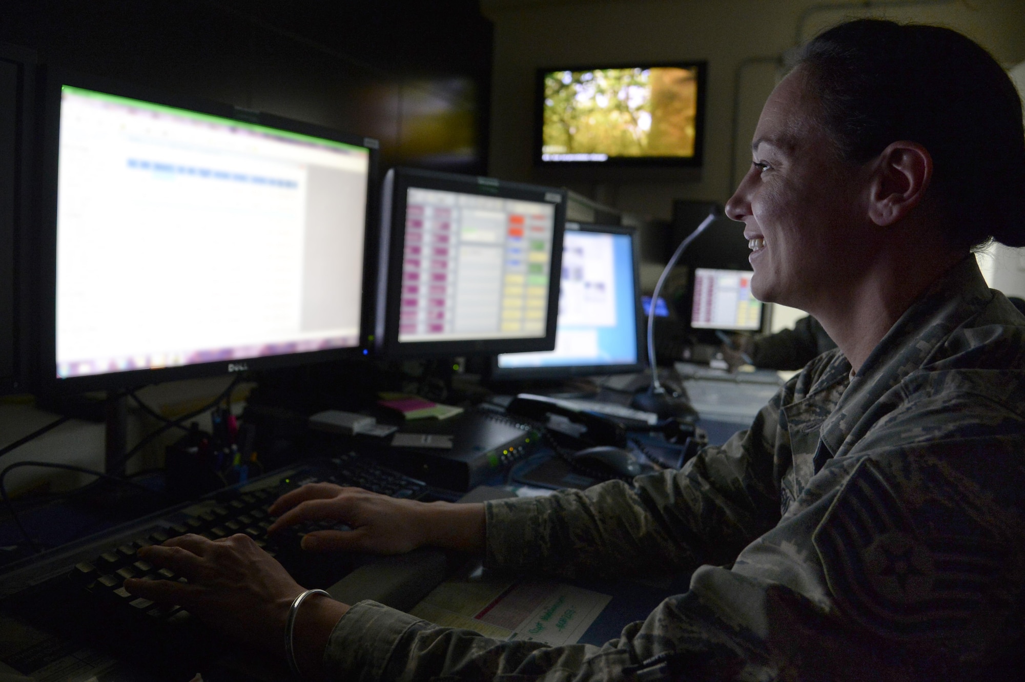 Tech. Sgt. Melanie, NCO in-charge console operations, monitors several computer systems to keep an eye on base happenings at an undisclosed location in Southwest Asia Feb. 3, 2015. Command Post Airmen are responsible for ensuring the flow of information and are essential to making sure the base operates smoothly and effectively. Melanie is currently deployed from Patrick Air Force Base, Fla., and is a native of Pensacola, Fla. (U.S. Air Force photo illustration/Tech. Sgt. Marie Brown)