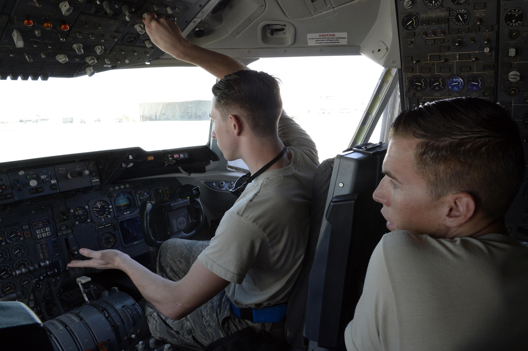 Airman 1st Class Taylor, right, KC-10 Extender crew chief, watches as Senior Airman Will, KC-10 Extender instrument and flight control systems technician, preforms an operational check on a KC-10 Extender at an undisclosed location in Southwest Asia Feb. 2, 2015.  Instrument and flight control system technicians are responsible for maintaining all aspects of flight controls, including autopilot systems and flight deck instrumentation. Taylor is currently deployed from Travis Air Force Base, Calif., and is a native of Belleview, S.D. Will is deployed from Travis AFB, Calif., and is a native of Glendale, Ariz. (U.S. Air Force photo/Tech. Sgt. Marie Brown)