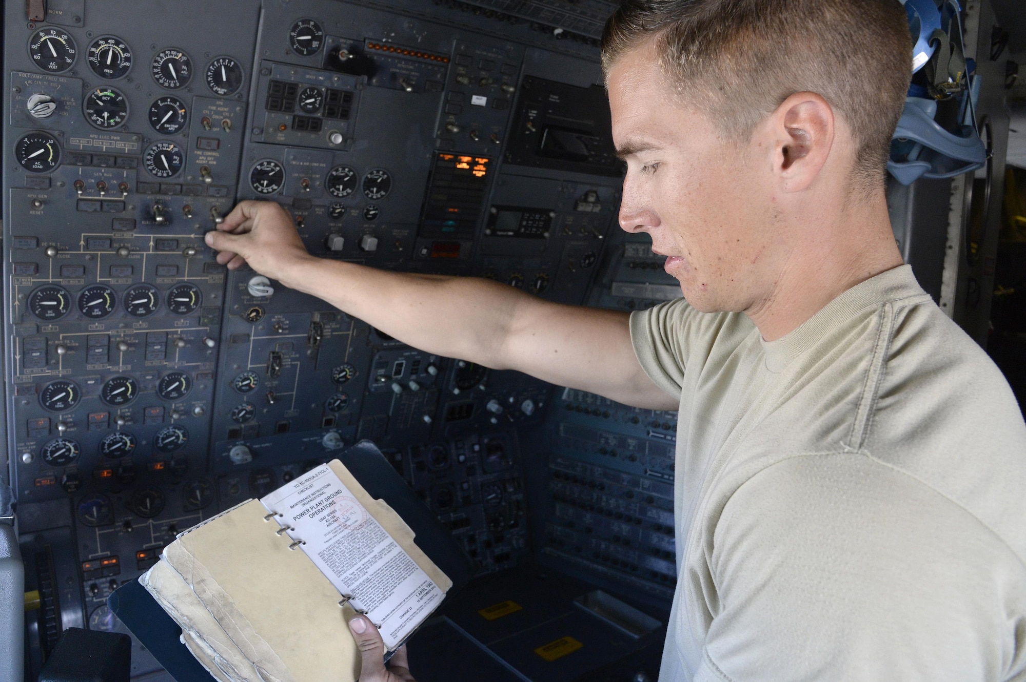 Airman 1st Class Taylor, KC-10 Extender crew chief, reads from his technical order during a preflight inspection aboard a KC-10 Extender at an undisclosed location in Southwest Asia Feb. 2, 2015.  Crew chiefs marshals, look over, inspect, and refuel the aircraft as well as making sure it is ready for another mission. Taylor is currently deployed from Travis Air Force Base, Calif., and is a native of Belleview, S.D. (U.S. Air Force photo/Tech. Sgt. Marie Brown)
