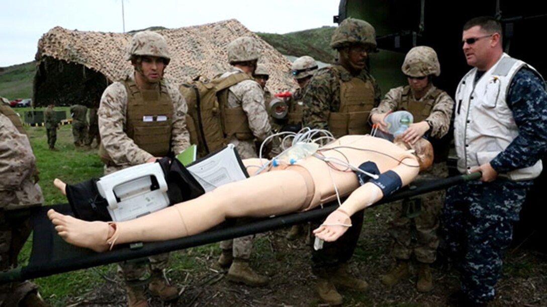 Corpsmen with Alpha Surgical Company, 1st Medical Battalion, 1st Marine Logistics Group, treat a simulated casualty during an en-route care exercise aboard Camp Pendleton, Calif., Jan. 28, 2015. During the four-day exercise, corpsmen trained to prepare a Special-Purpose Marine Air-Ground Task Force group that is going to forward deploy later this year. The more than 40 corpsmen set up a shock trauma platoon facility, or mobile emergency room, to treat simulated casualties. The casualties were stabilized in the STP and then flown out via aircraft. (U.S. Marine Corps photo by Sgt. Laura Gauna/Released)