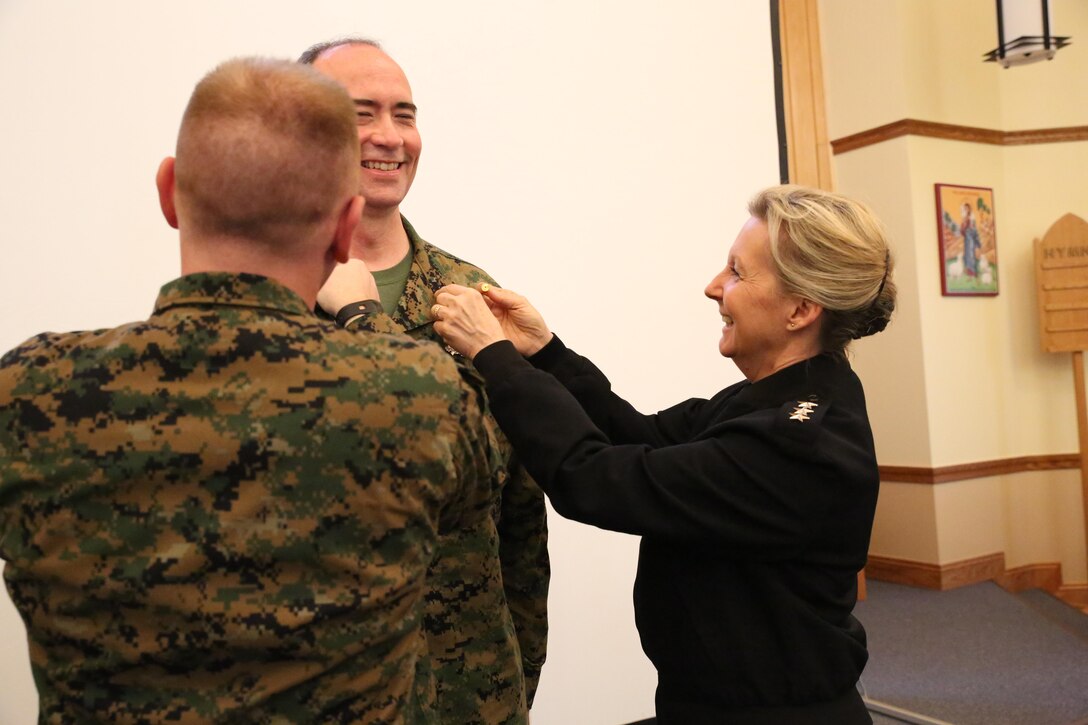 Vice Admiral Robin Braun, chief of the Navy Reserve, and Religious Program Specialist Seaman Kobi Cupps, an RP with Marine Expeditionary Fleet Religious Support Unit, promote Daniel Dodds, 4th Marine Division Force RP, to the rank of master chief at the Marine Forces Reserve Chaplaincy Training seminar at Naval Air Station Joint Reserve Base New Orleans, Feb. 5, 2015. Dodds currently fills the only Reserve master chief rank opening in the religious program specialist rating. The MARFORRES Chaplaincy training seminar focused on preparing chaplains and RPs throughout MARFORRES to support Reserve Marines across the world. 