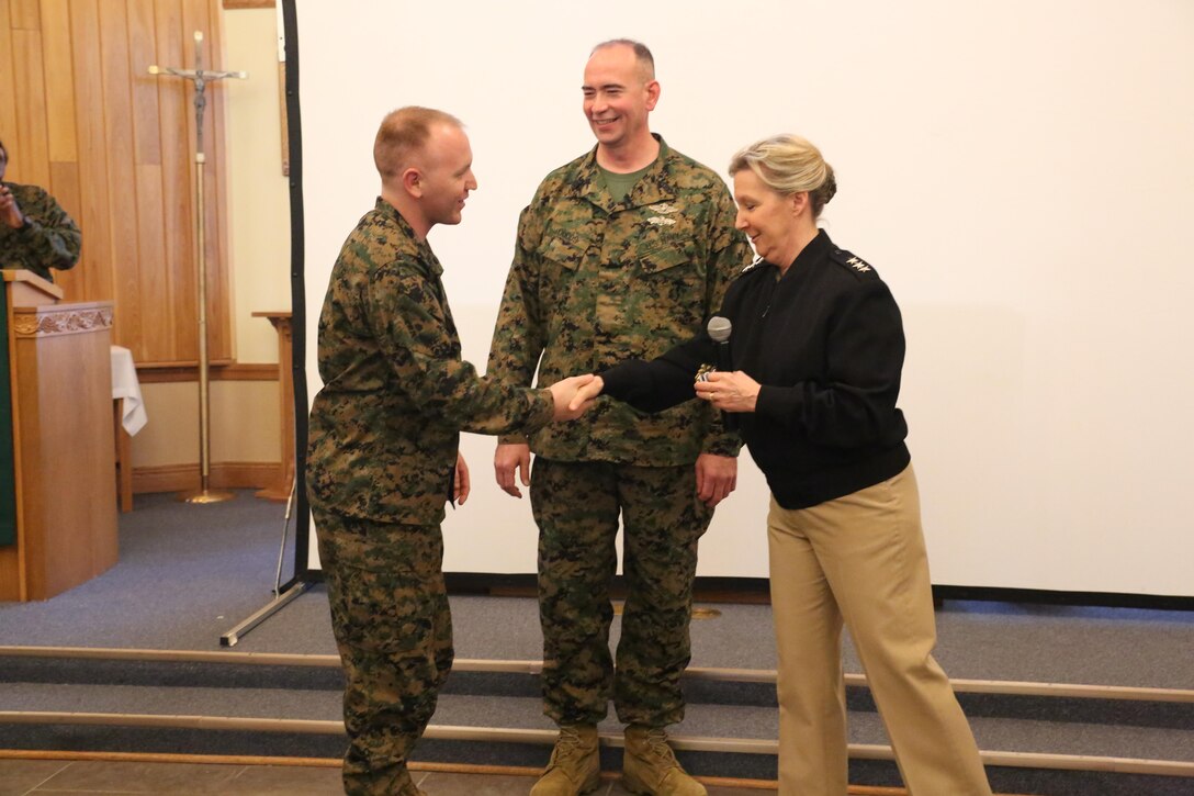 Vice Admiral Robin Braun, chief of the Navy Reserve, presents Navy Reserve Centennial coins to Religious Program Specialist Seaman Kobi Cupps, an RP with Marine Expeditionary Fleet Religious Support Unit, and Religious Programs Master Chief Daniel Dodds, 4th Marine Division Force RP, at the Marine Forces Reserve Chaplaincy Training seminar at Naval Air Station Joint Reserve Base New Orleans, Feb. 5, 2015. Braun spoke about the Navy Reserve’s goals for the next 10 years, including cultivating leadership, advancing technology, furthering force readiness and relevance, as well as upcoming changes to the Navy Reserve in light of its 100th anniversary on March 3, 2015. Established during World War I, the Navy Reserve’s mission is to deliver strategic depth and operational capabilities to the Navy, Marine Corps, and joint forces. The MARFORRES Chaplaincy training seminar focused on preparing chaplains and RPs throughout MARFORRES to support Reserve Marines across the world. 