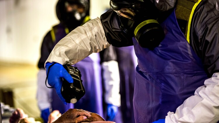 A Marine with the Chemical Biological Incident Response Force, II Marine Expeditionary Force uses a device to detect contamination on a non-transferable anatomic material during a training evolution at the Guardian Center in Perry, Ga. on February 4, 2015.  The training aims to provide the Marines and Sailors with realistic crisis response scenarios.  (U.S. Marine Corps photo by: Sgt. Fareeza Ali/USMC)