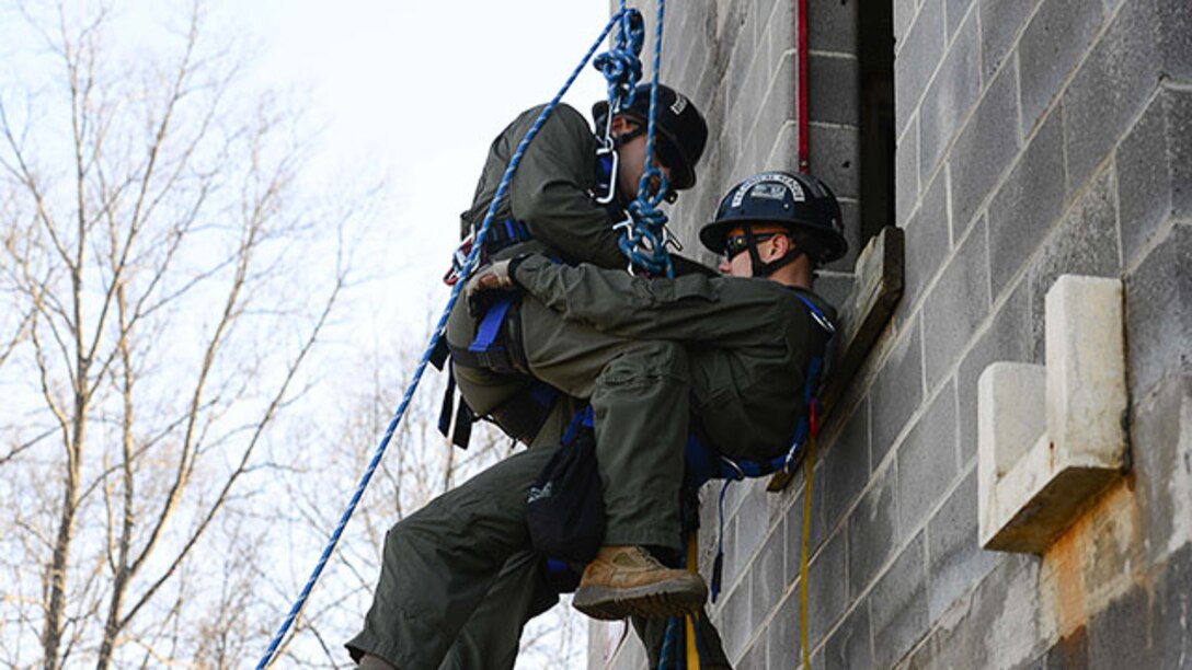 Marines with Technical Rescue Platoon, Chemical Biological Incident Response Force, attach to each other during a rappel rescue training scenario, Feb. 3, at Henrico Fire Drill Facility in Glen Allen, Virginia. During this scenario, one of the Marines simulate having faulty equipment, allowing the other Marine to attach to the victim and assist him down the tower.