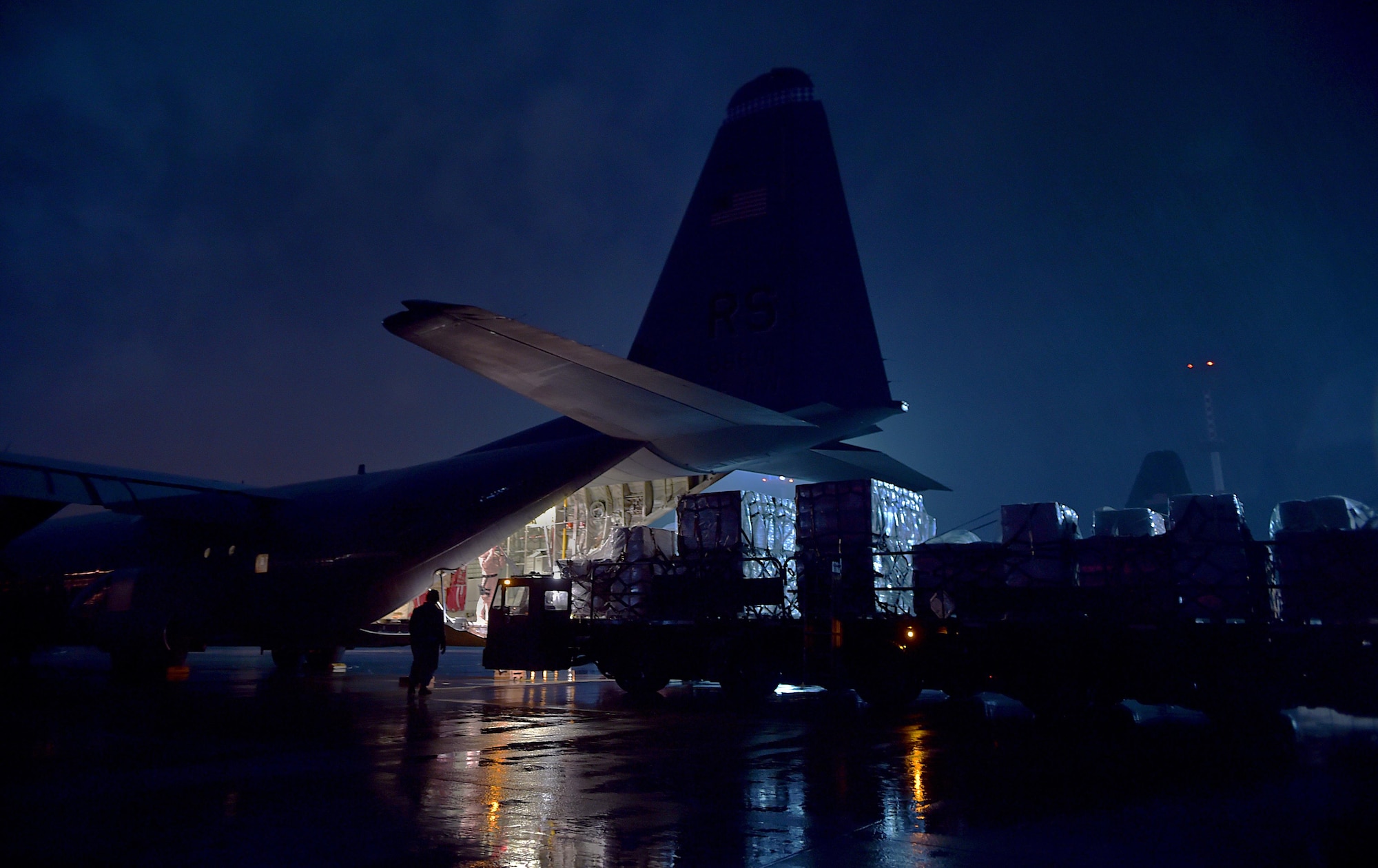 Cargo is loaded onto the ramp of a C-130-J Super Hercules Oct. 7, 2014, at Ramstein Air Base, Germany. As the Ebola outbreak becomes a potential global threat, U.S. Africa Command is working in support of the U.S. Agency for International Development, the lead federal agency, as part of a comprehensive U.S. government effort to respond to and contain the outbreak of the Ebola virus in West Africa as quickly as possible. This was the first flight launched from Ramstein AB to Monrovia, Liberia, in support of Operation United Assistance. (U.S. Air Force photo/Staff Sgt. Sara Keller)