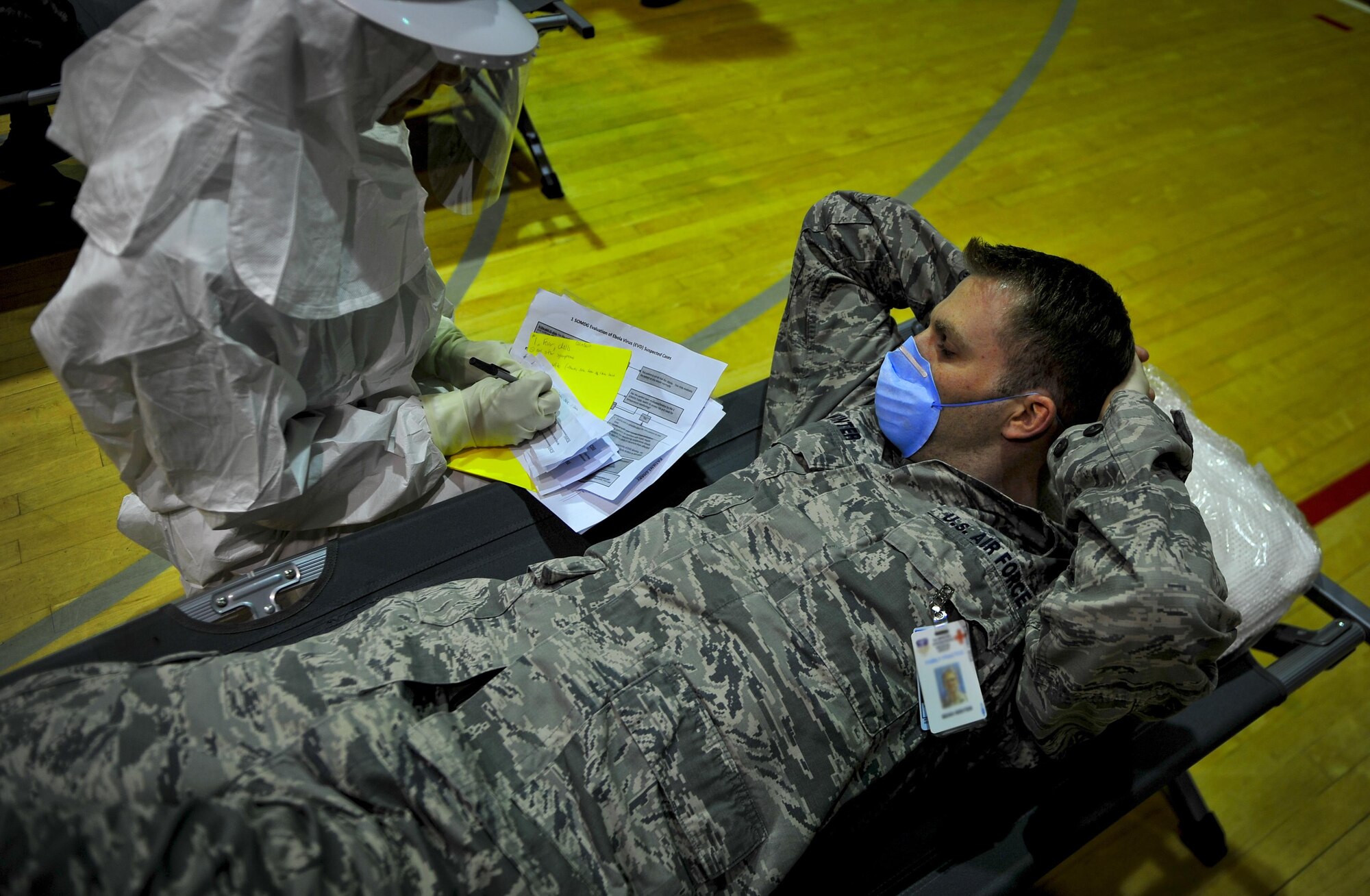 Staff Sgt. Sean Winter, 1st Special Operations Medical Group, simulates symptoms during a disease containment exercise at Hurlburt Field, Fla., Feb. 4, 2015. The medical staff focused on the interaction and coordination between multiple units that would be involved in responding to a disease outbreak. (U.S. Air Force photo/Senior Airman Christopher Callaway)