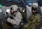 YOKOTA AIR BASE, Japan  (Jan. 29, 2015) - Members of the Japan Ground Self-Defense Force ride along with U.S. Service members as they perform formation maneuvers during a bilateral training mission near Tokyo, Japan. U.S. and JGSDF members conducted the exchange mission to deepen their understanding of tactics, techniques and procedures each other’s use. 