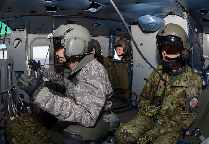 YOKOTA AIR BASE, Japan  (Jan. 29, 2015) - Members of the Japan Ground Self-Defense Force ride along with U.S. Service members as they perform formation maneuvers during a bilateral training mission near Tokyo, Japan. U.S. and JGSDF members conducted the exchange mission to deepen their understanding of tactics, techniques and procedures each other’s use. 