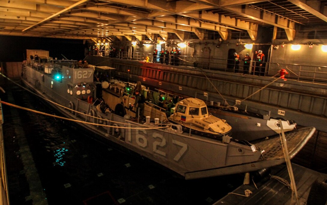 U.S. Marines with Battalion Landing Team, 3rd Battalion, 1st Marine Regiment, 15th Marine Expeditionary Unit, prepare to disembark the USS Rushmore (LSD 47) in a landing craft utility off the coast of Camp Pendleton, Calif., Jan. 25, 2015. The 15th MEU was embarked aboard the three ships of the Essex Amphibious Ready Group - the USS Essex (LHD 2), USS Anchorage (LPD 23), and USS Rushmore – from Jan. 22-25 to familiarize themselves with the ships as they continue to prepare for their upcoming deployment this spring. (U.S. Marine Corps photo by Cpl. Steve H. Lopez/Released)