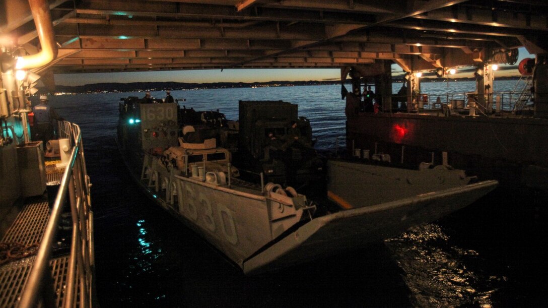 U.S. Marines with Battalion Landing Team, 3rd Battalion, 1st Marine Regiment, 15th Marine Expeditionary Unit, in an landing craft utility disembarks the USS Rushmore (LSD 47) off the coast of Camp Pendleton, Calif., Jan. 25, 2015. The 15th MEU was embarked aboard the three ships of the Essex Amphibious Ready Group - the USS Essex (LHD 2), USS Anchorage (LPD 23), and USS Rushmore – from Jan. 22-25 to familiarize themselves with the ships as they continue to prepare for their upcoming deployment this spring. (U.S. Marine Corps photo by Cpl. Steve H. Lopez/Released)