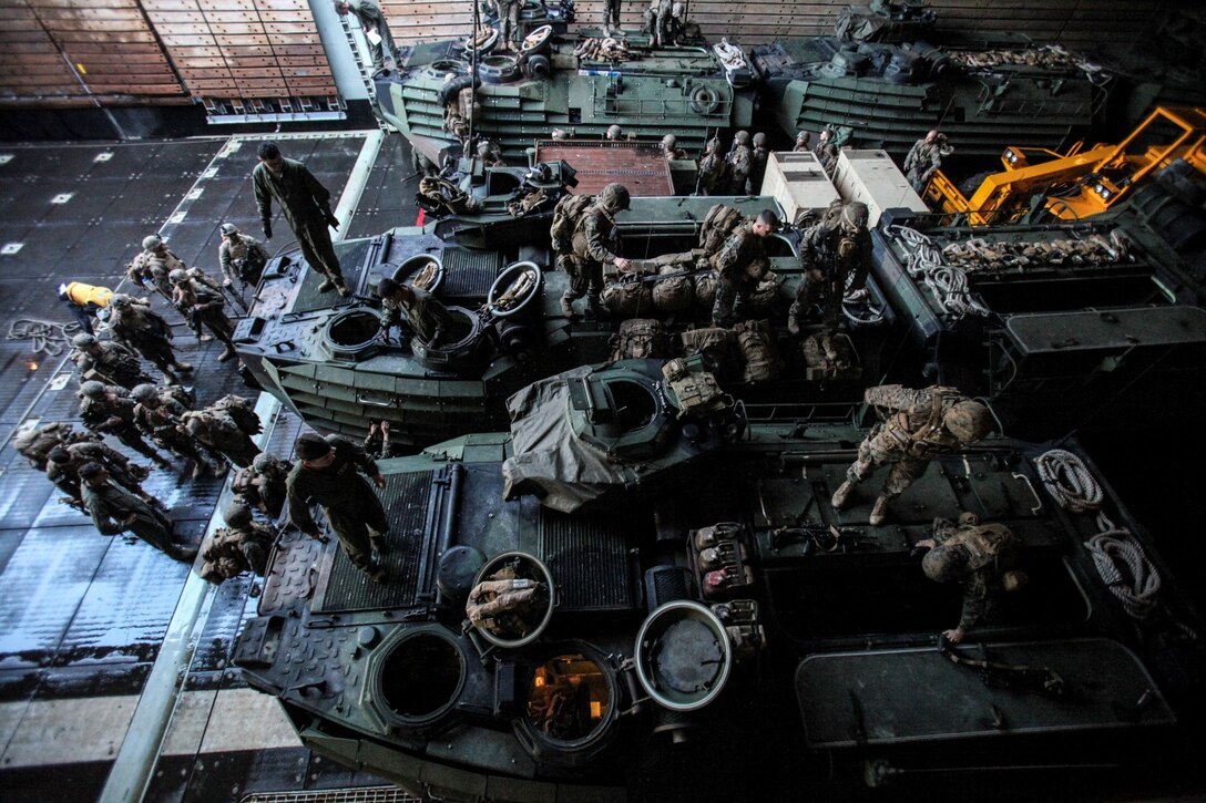 U.S. Marines with Battalion Landing Team, 3rd Battalion, 1st Marine Regiment, 15th Marine Expeditionary Unit, load in AAV-7 Amphibious Assault Vehicles in order to disembark the USS Rushmore (LSD 47) off the coast of Camp Pendleton, Calif., Jan. 25, 2015. The 15th MEU was embarked aboard the three ships of the Essex Amphibious Ready Group - the USS Essex (LHD 2), USS Anchorage (LPD 23), and USS Rushmore – from Jan. 22-25 to familiarize themselves with the ships as they continue to prepare for their upcoming deployment this spring. (U.S. Marine Corps photo by Cpl. Steve H. Lopez/Released)