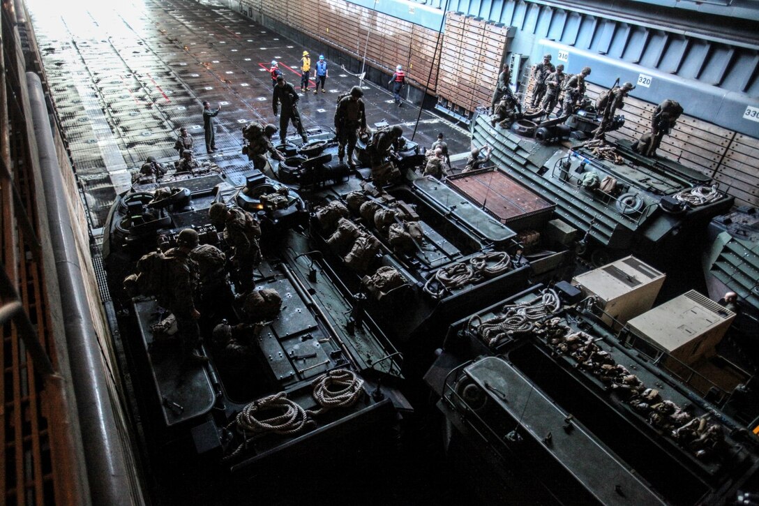 U.S. Marines with Battalion Landing Team, 3rd Battalion, 1st Marine Regiment, 15th Marine Expeditionary Unit, load in AAV-7 Amphibious Assault Vehicles in order to disembark the USS Rushmore (LSD 47) off the coast of Camp Pendleton, Calif., Jan. 25, 2015. The 15th MEU was embarked aboard the three ships of the Essex Amphibious Ready Group - the USS Essex (LHD 2), USS Anchorage (LPD 23), and USS Rushmore – from Jan. 22-25 to familiarize themselves with the ships as they continue to prepare for their upcoming deployment this spring. (U.S. Marine Corps photo by Cpl. Steve H. Lopez/Released)