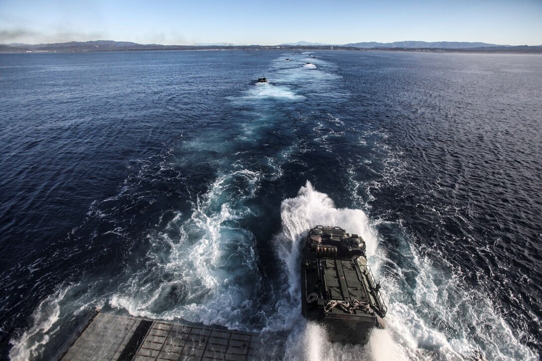 U.S. Marines with Battalion Landing Team, 3rd Battalion, 1st Marine Regiment, 15th Marine Expeditionary Unit, in AAV-7 Amphibious Assault Vehicles in order to disembark the USS Rushmore (LSD 47) off the coast of Camp Pendleton, Calif., Jan. 25, 2015. The 15th MEU was embarked aboard the three ships of the Essex Amphibious Ready Group - the USS Essex (LHD 2), USS Anchorage (LPD 23), and USS Rushmore – from Jan. 22-25 to familiarize themselves with the ships as they continue to prepare for their upcoming deployment this spring. (U.S. Marine Corps photo by Cpl. Steve H. Lopez/Released)