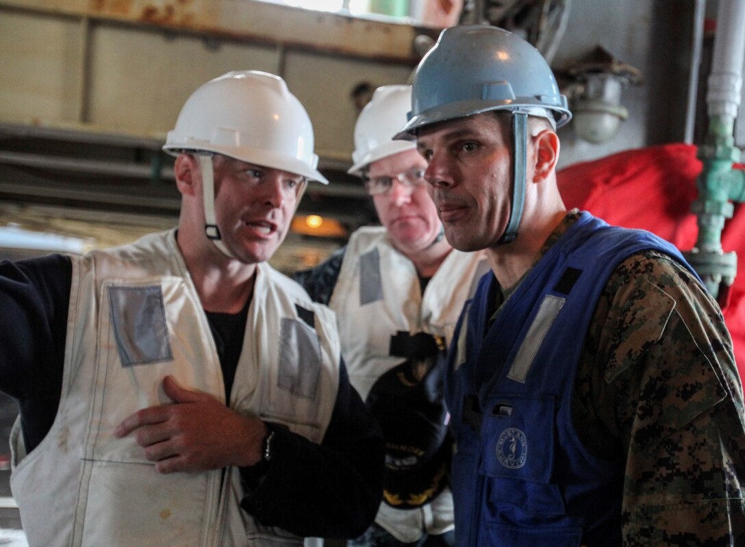 U.S. Navy Cmdr. Thomas S. Stephens, left, gives Marine Col. Vance L. Cryer a tour of the well deck aboard the USS Rushmore (LSD 47) off the coast of Camp Pendleton, Calif., Jan. 25, 2015. Stephens is the commanding officer of the USS Rushmore. Cryer is the commanding officer of the 15th Marine Expeditionary Unit. The 15th MEU was embarked aboard the three ships of the Essex Amphibious Ready Group - the USS Essex (LHD 2), USS Anchorage (LPD 23), and USS Rushmore – from Jan. 22-25 to familiarize themselves with the ships as they continue to prepare for their upcoming deployment this spring. (U.S. Marine Corps photo by Cpl. Steve H. Lopez/Released)
